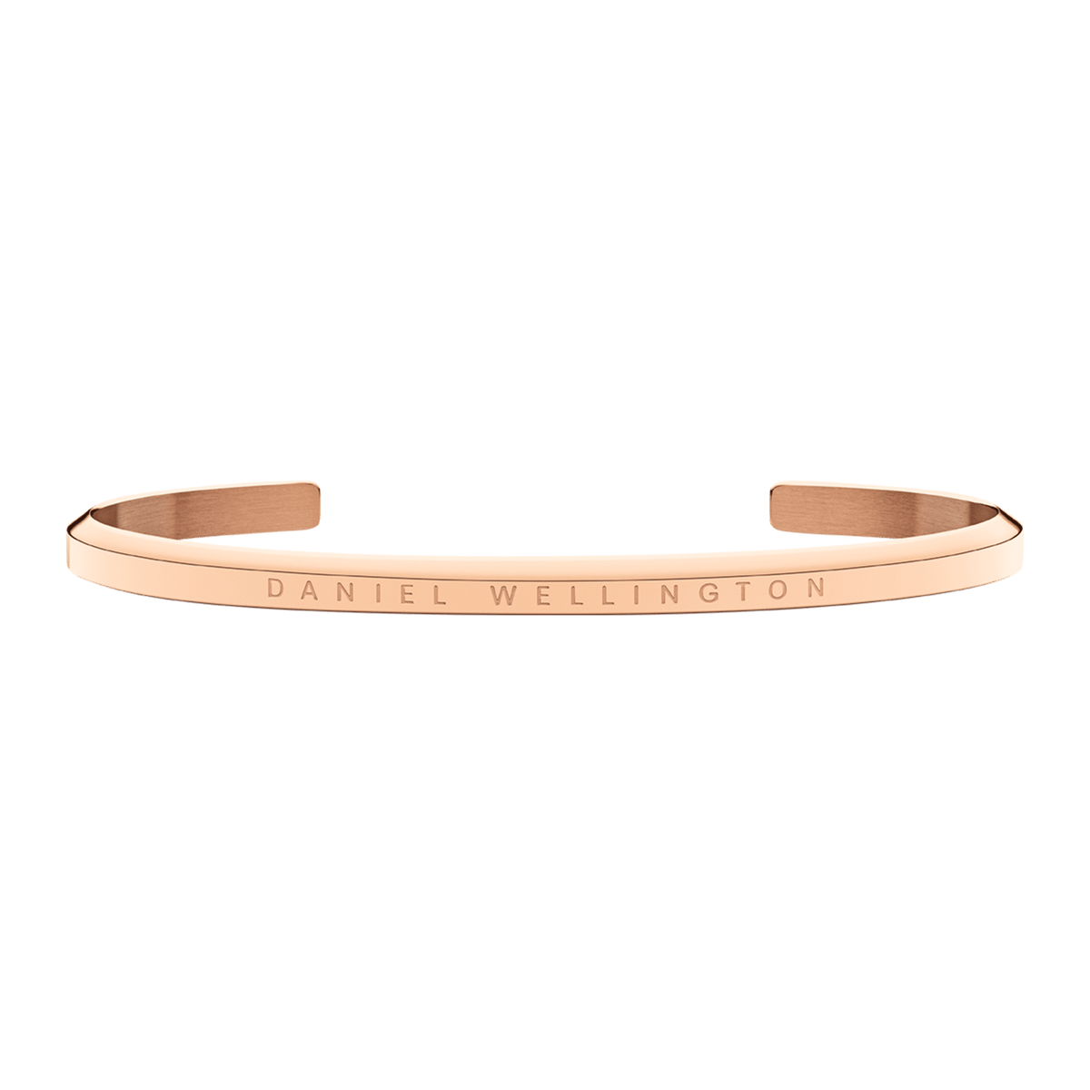Slim rose gold Daniel Wellington cuff bracelet with engraved logo, minimalist open design, polished stainless steel finish.