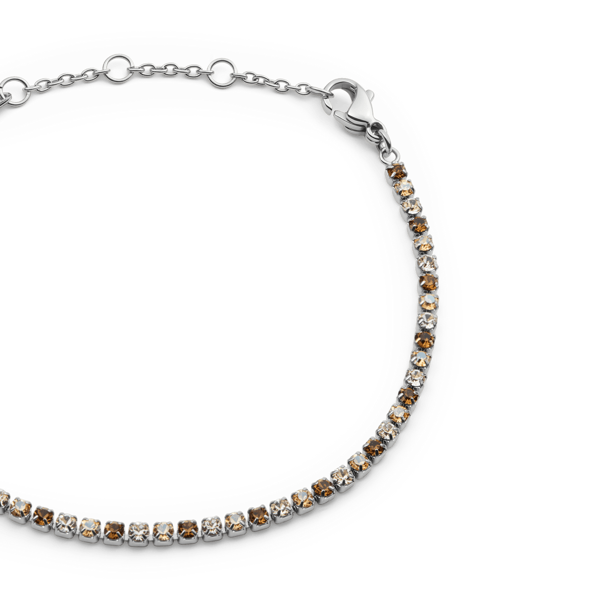 Close-up of the Classic Tennis Bracelet Honey Combo Silver, featuring a slim silver chain with individually set honey-toned and clear Preciosa crystals, finished with an adjustable lobster clasp.