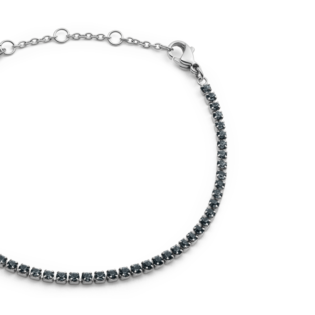Close-up of the Classic Tennis Bracelet Nightfall Silver, featuring individually set black Preciosa crystals along a slender silver chain with adjustable sizing rings and a secure lobster clasp.