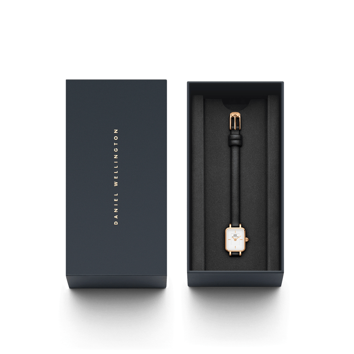 Quadro Mini Sheffield Rose Gold watch with a rectangular rose gold case and black leather strap, elegantly presented in a dark Daniel Wellington gift box.