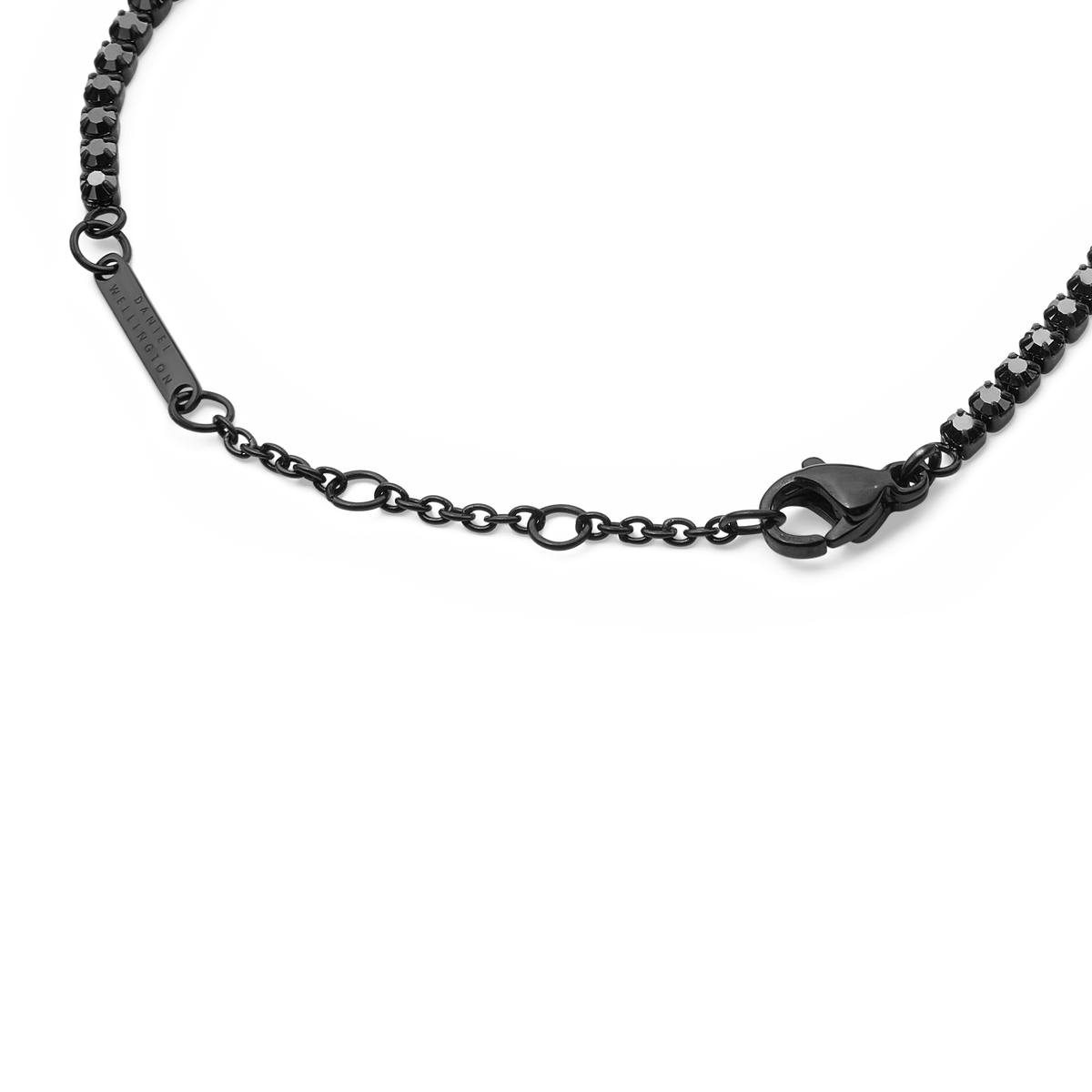 Detail of the Black Crystal Tennis Bracelet showing the adjustable sizing rings, lobster clasp, and individually set black Preciosa crystals in a black stainless steel setting.