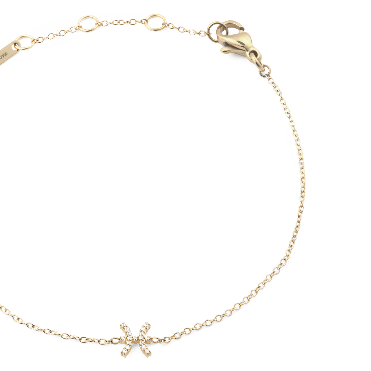 Delicate gold chain bracelet featuring a sparkling crystal zodiac pendant with adjustable sizing rings and a secure lobster clasp.