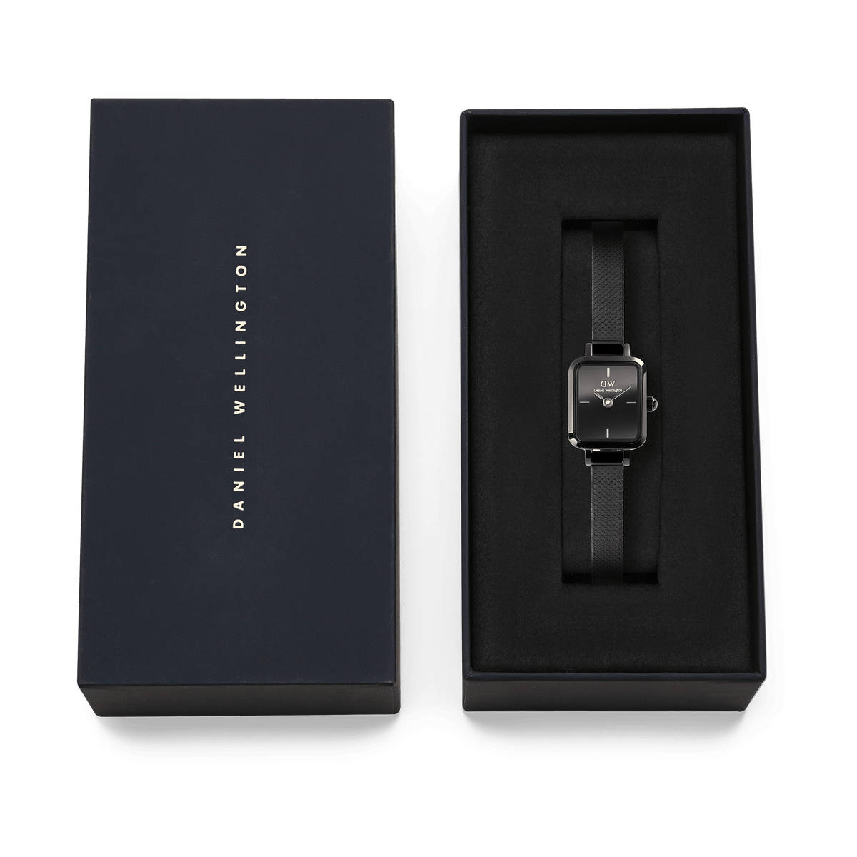 Quadro Mini Reflection Black women’s watch with a rectangular mirror dial and black mesh strap, elegantly presented in a Daniel Wellington gift box.