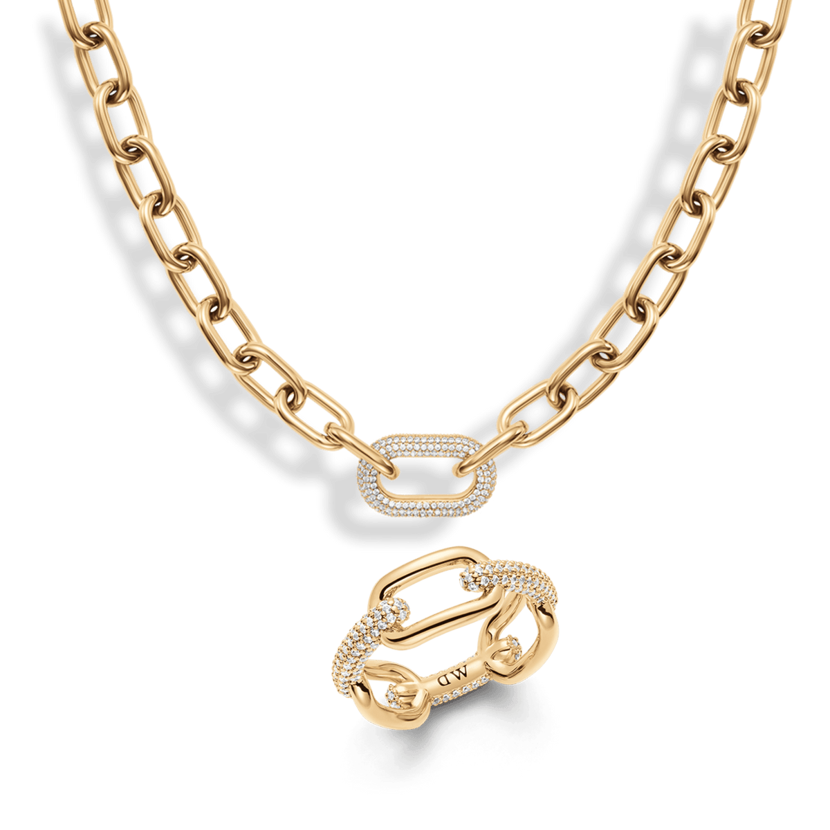 Gold chain necklace and matching ring set, both featuring bold links and a central pavé crystal-embellished link for a modern, elegant finish. The polished gold tone and sparkling crystal accents create a cohesive, sophisticated jewellery look.