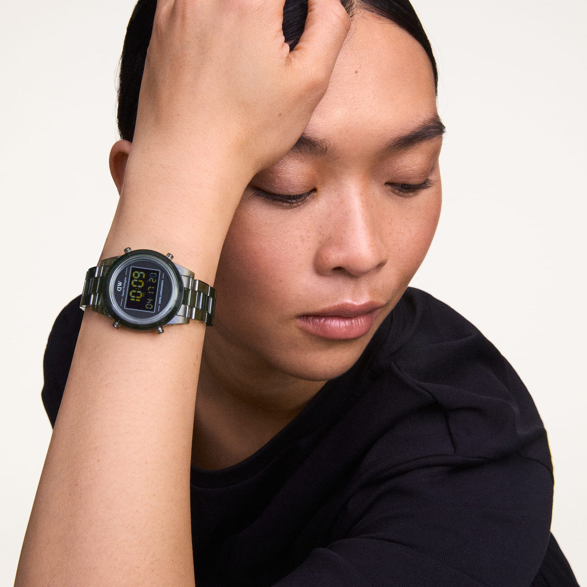 Person wearing the Retro Digital Dark Green watch with a transparent dark green strap and black digital dial, styled casually with a short-sleeve black top.