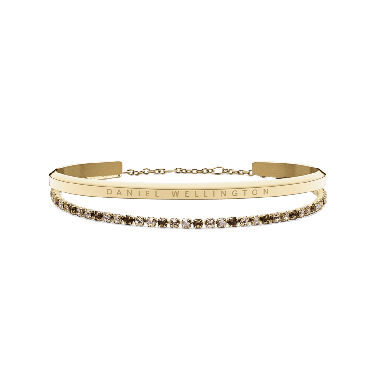 Gold bracelet set featuring a sleek Daniel Wellington engraved cuff paired with a delicate tennis bracelet adorned with honey-toned crystals, both finished in polished gold for an elegant and timeless look.