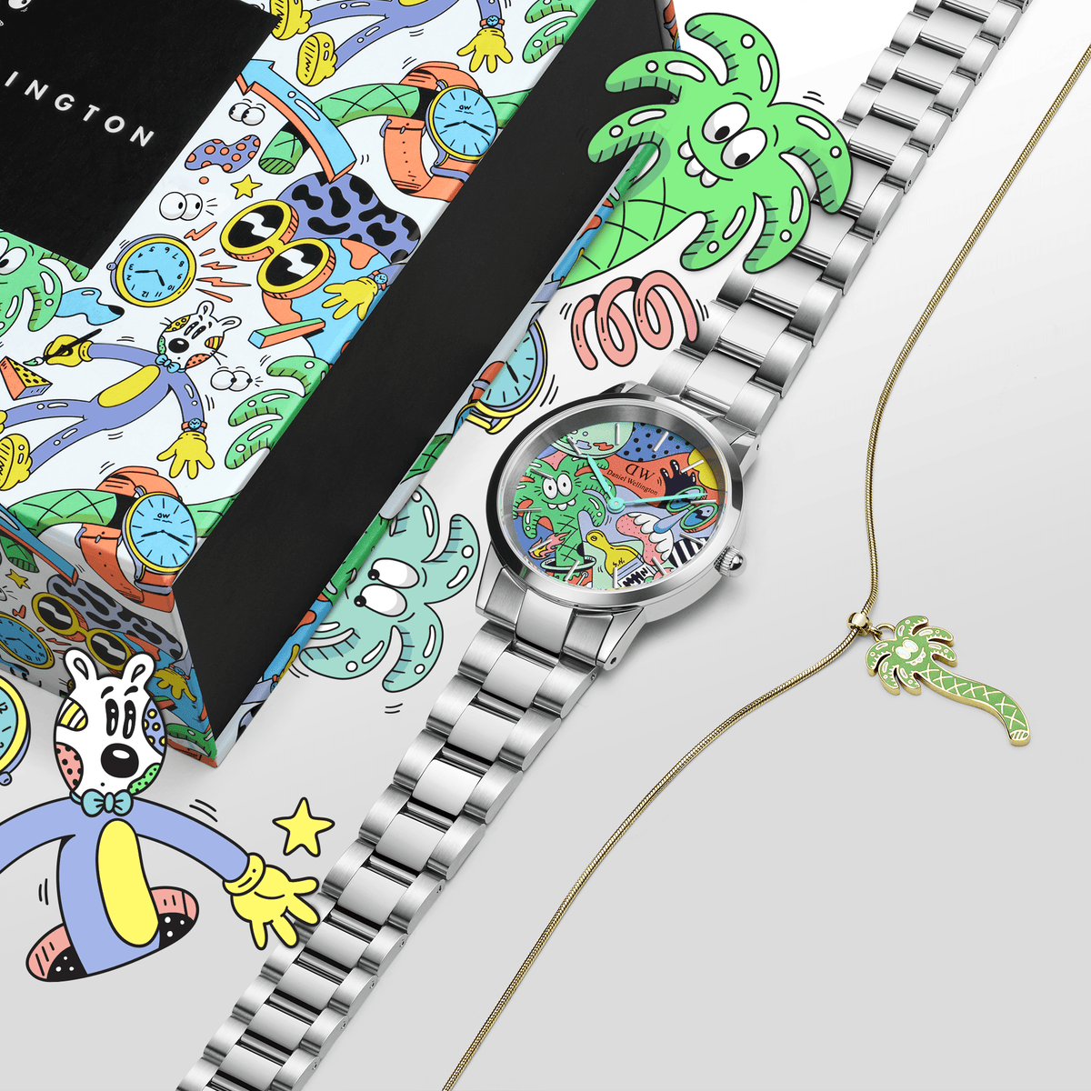 Steven Harrington x Daniel Wellington limited edition set featuring a silver steel link watch with a vibrant multicolour graphic dial and a gold necklace with a green palm tree charm, displayed alongside matching artist-designed packaging.