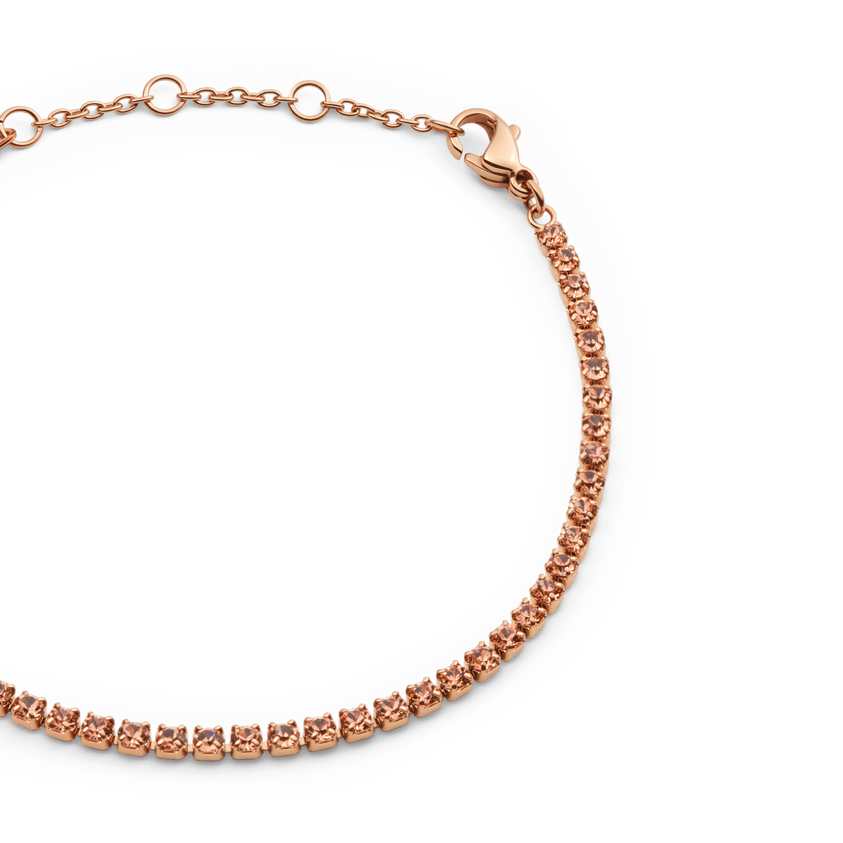 Close-up of the Classic Tennis Bracelet Apricot Rose Gold, showing individually set apricot-coloured Preciosa crystals on a slender rose gold chain with an adjustable lobster clasp.