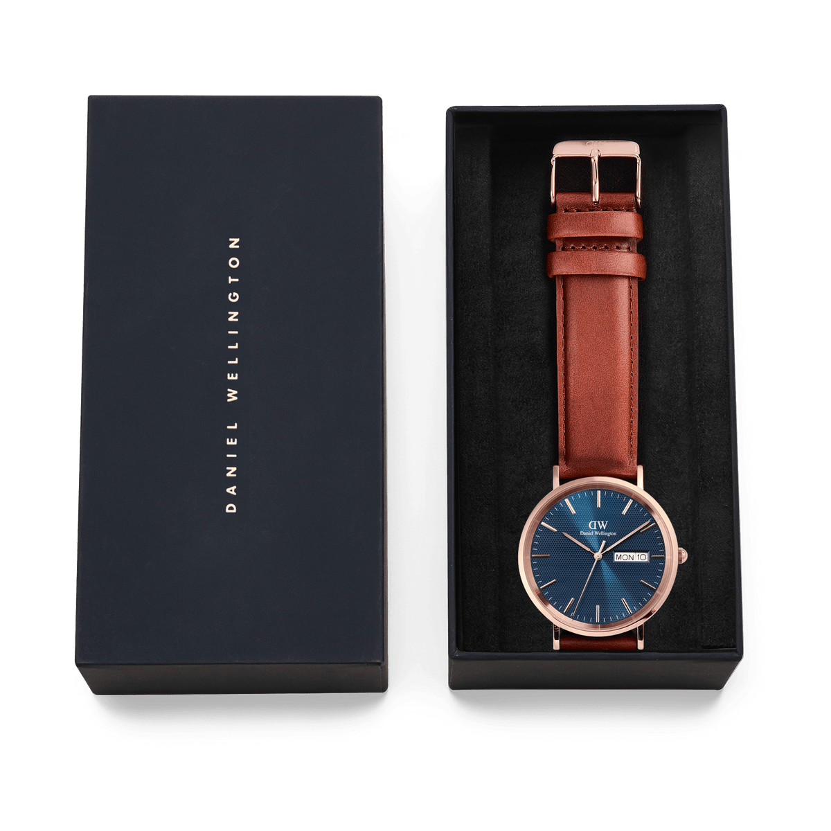 Classic Day Display St Mawes Rose Gold Arctic watch with a blue dial and brown leather strap, presented in an elegant Daniel Wellington gift box.