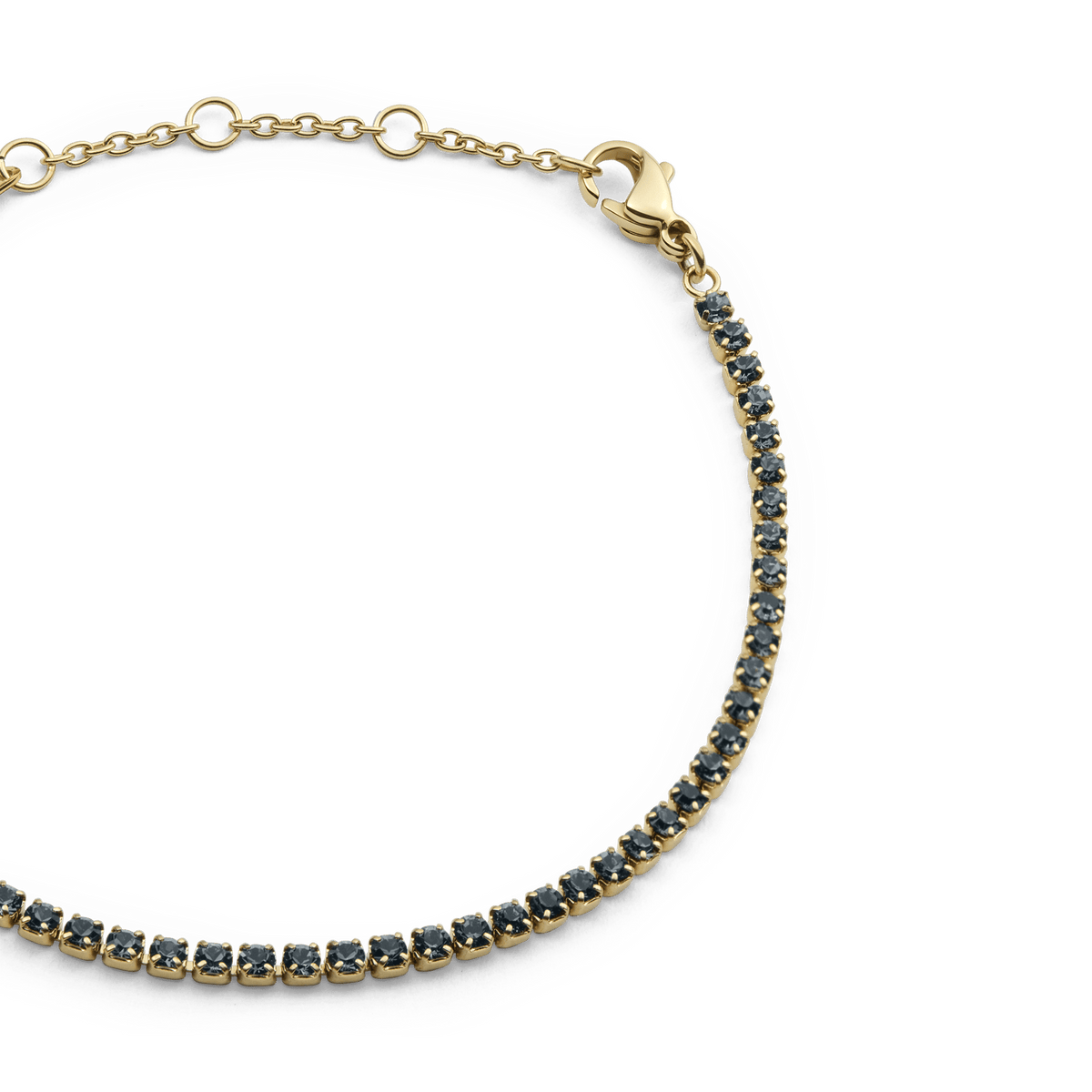Classic Tennis Bracelet Nightfall Gold featuring a slim gold chain with individually set dark Preciosa crystals and an adjustable lobster clasp fastening.