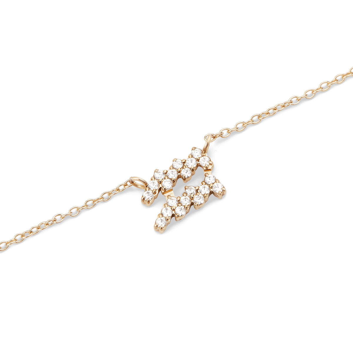 Close-up of a gold chain necklace featuring a zodiac pendant encrusted with sparkling hand-set crystals.