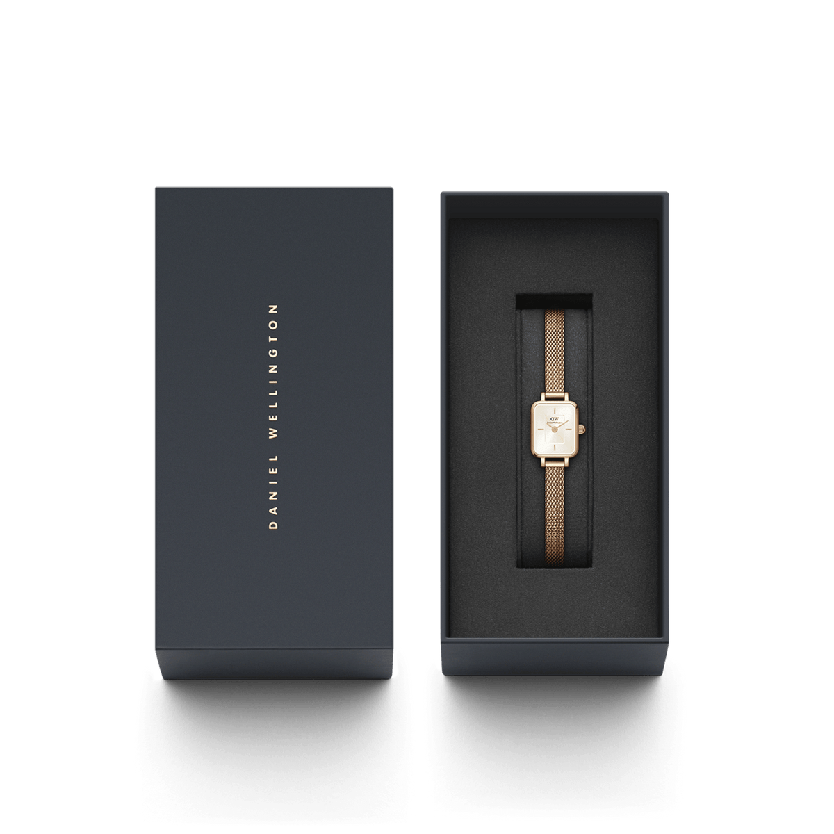 Quadro Mini Melrose Champagne women’s watch with a rectangular champagne dial and rose gold mesh strap, elegantly presented in a black Daniel Wellington gift box.