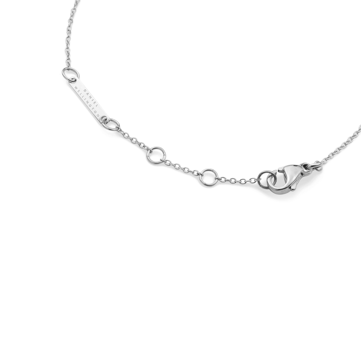 Close-up of the Crystal Zodiac Chain Bracelet Silver showing the adjustable sizing rings, secure lobster clasp, and Daniel Wellington engraved tag.