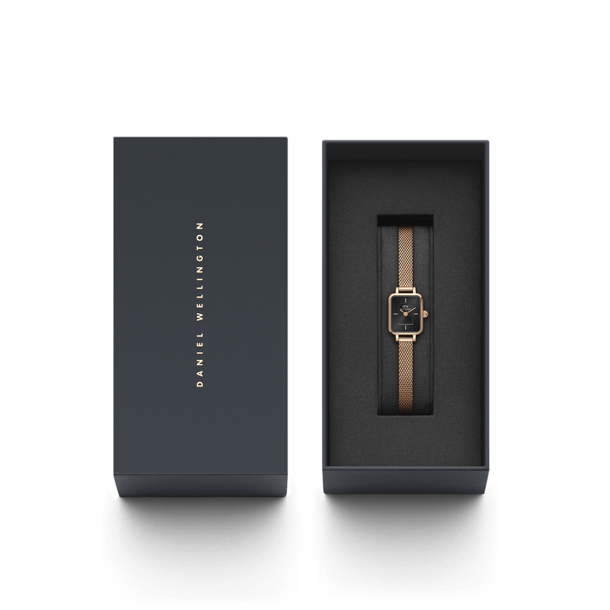 Quadro Mini Melrose Onyx women’s watch with a rose gold mesh strap and black rectangular dial, elegantly presented in a dark Daniel Wellington gift box.