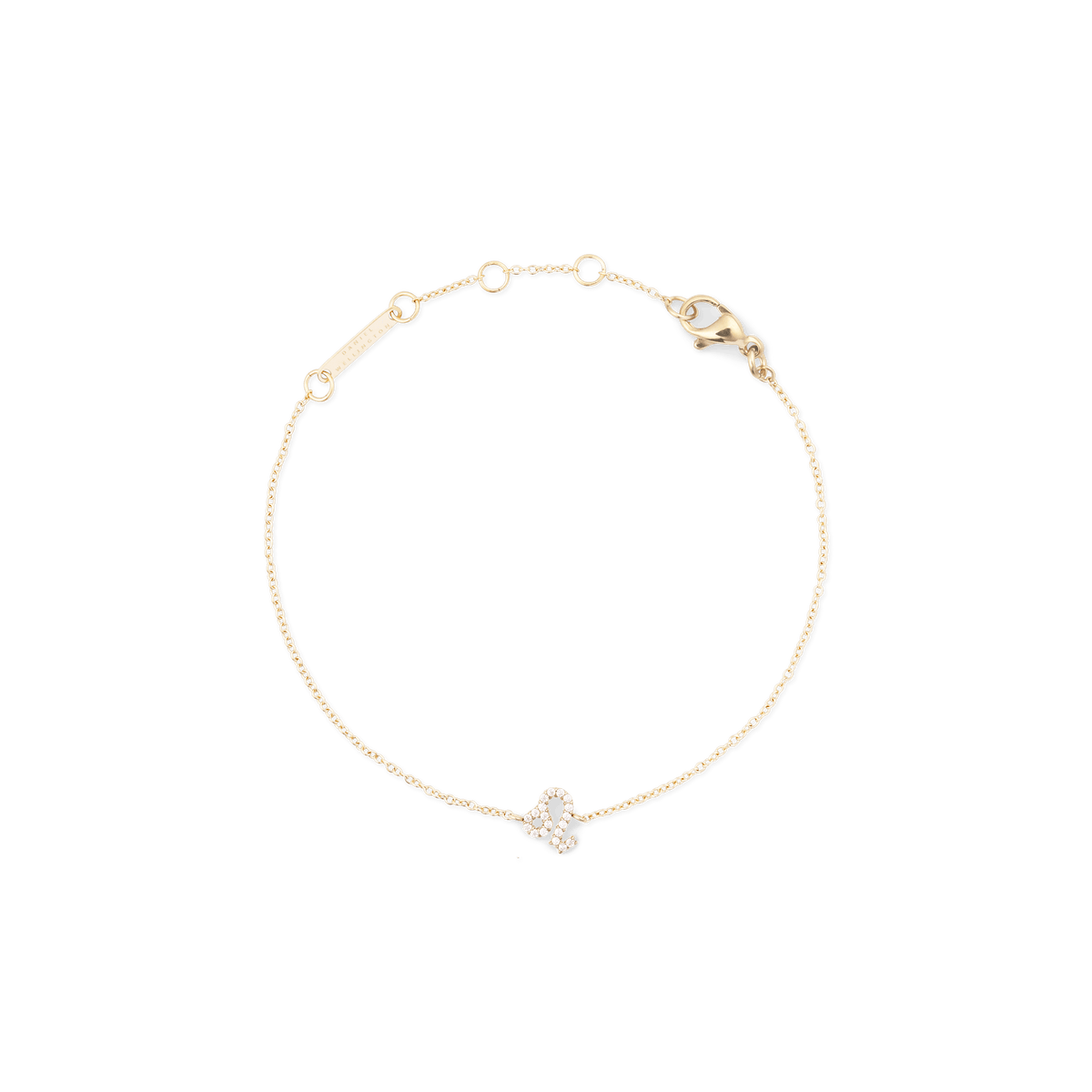 Slim gold chain bracelet with an adjustable clasp, featuring a crystal-encrusted zodiac pendant in a minimalist design.