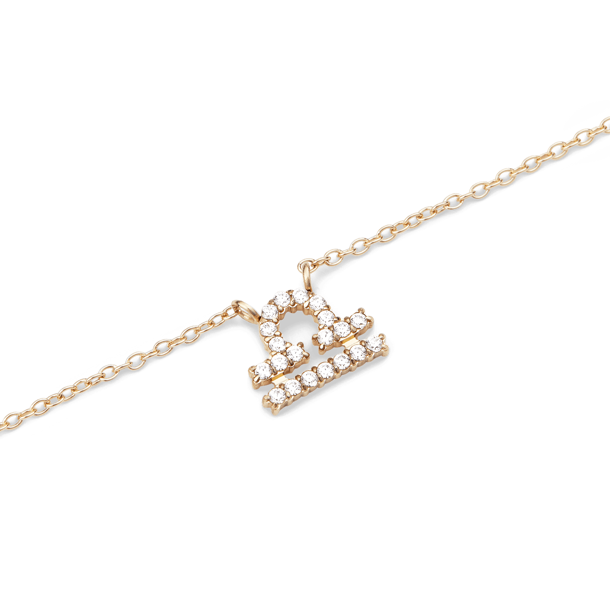 Gold chain necklace featuring a Libra zodiac pendant adorned with sparkling hand-set crystals.
