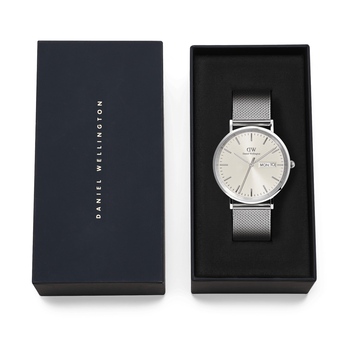 Classic Day Display Sterling Champagne watch with a silver mesh strap and champagne dial, presented in an elegant Daniel Wellington gift box.