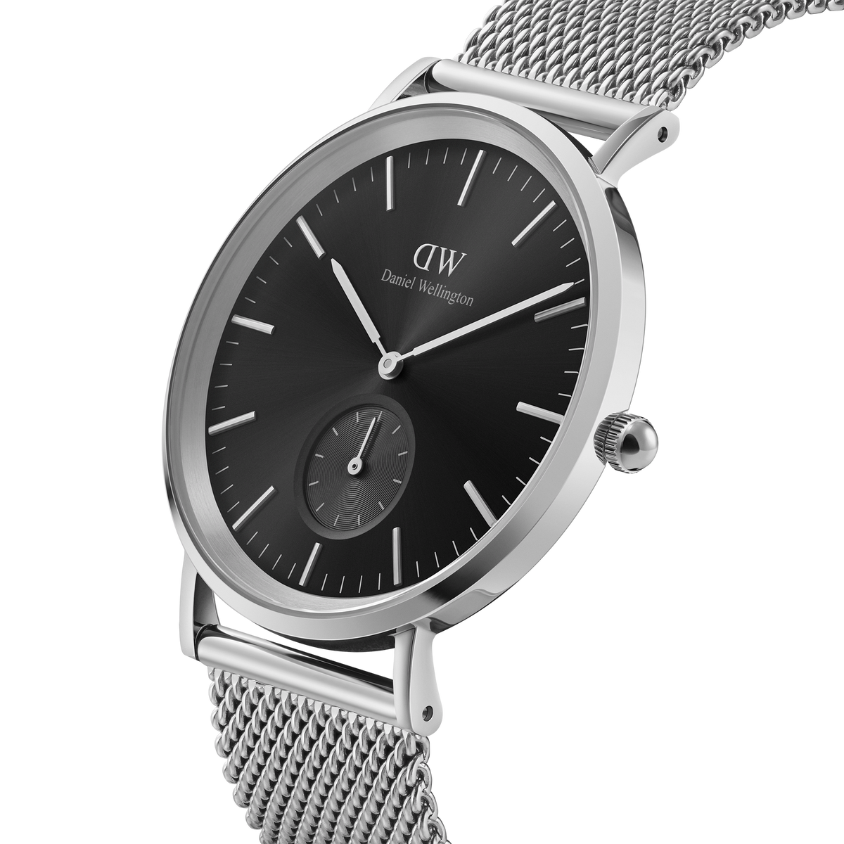 Classic Multi-Eye Sterling Onyx men’s watch featuring a sleek black dial with a seconds sub-dial, polished stainless steel case, and a refined silver mesh strap.