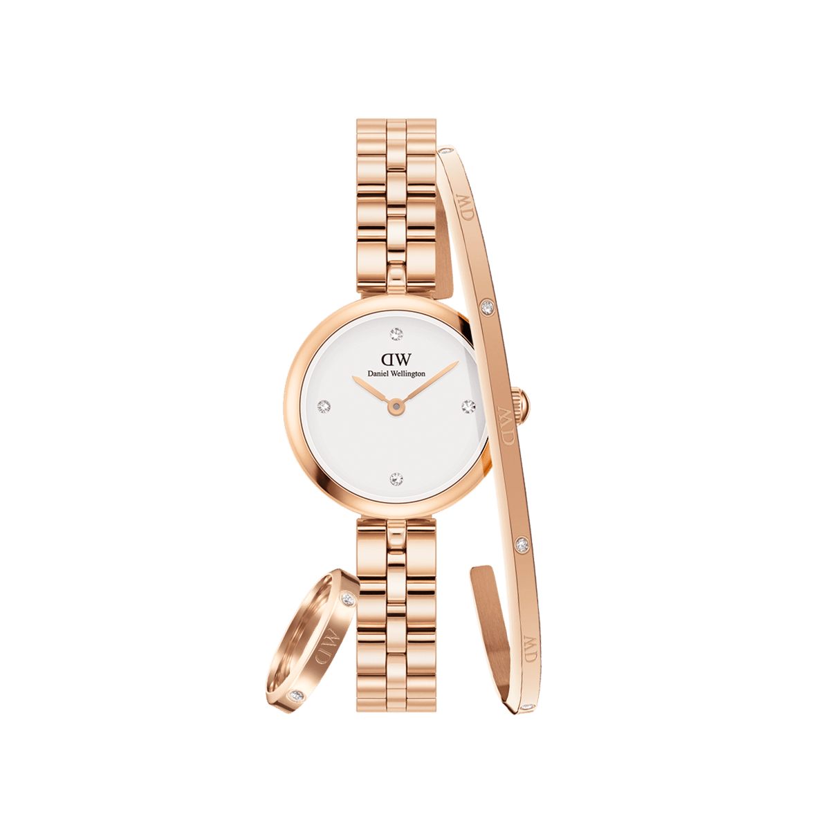 Rose gold women’s watch with a white dial and crystal hour markers, paired with a matching rose gold bracelet and ring, each featuring subtle crystal accents and Daniel Wellington branding.