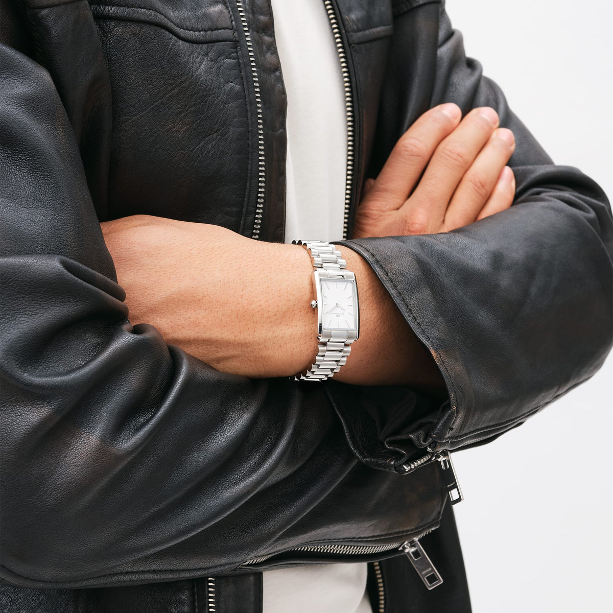 Man wearing Bound 3-Link Silver rectangular stainless steel watch with white dial, styled with a black leather jacket.