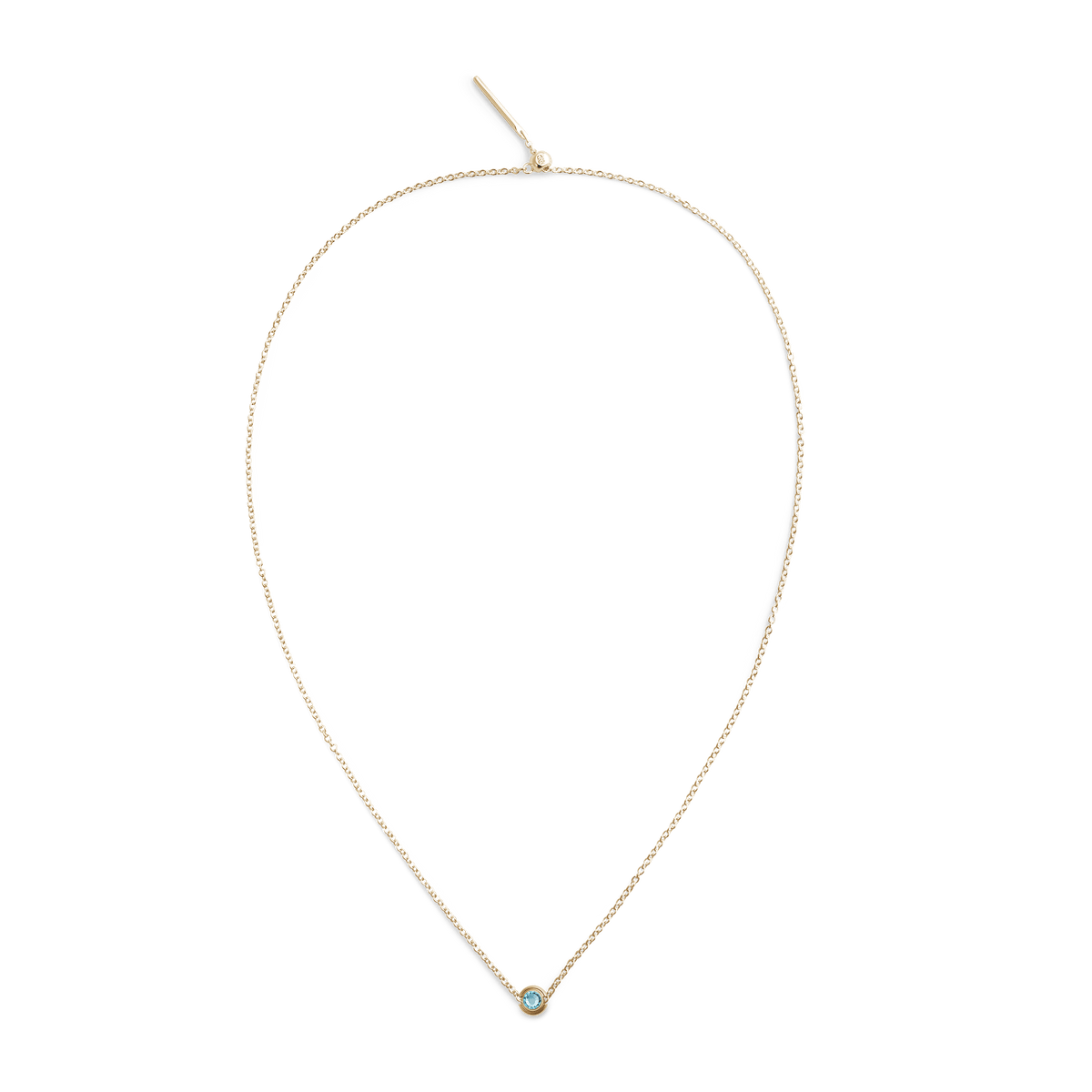 Delicate gold chain necklace featuring a small turquoise blue December birthstone charm set in gold-plated stainless steel.