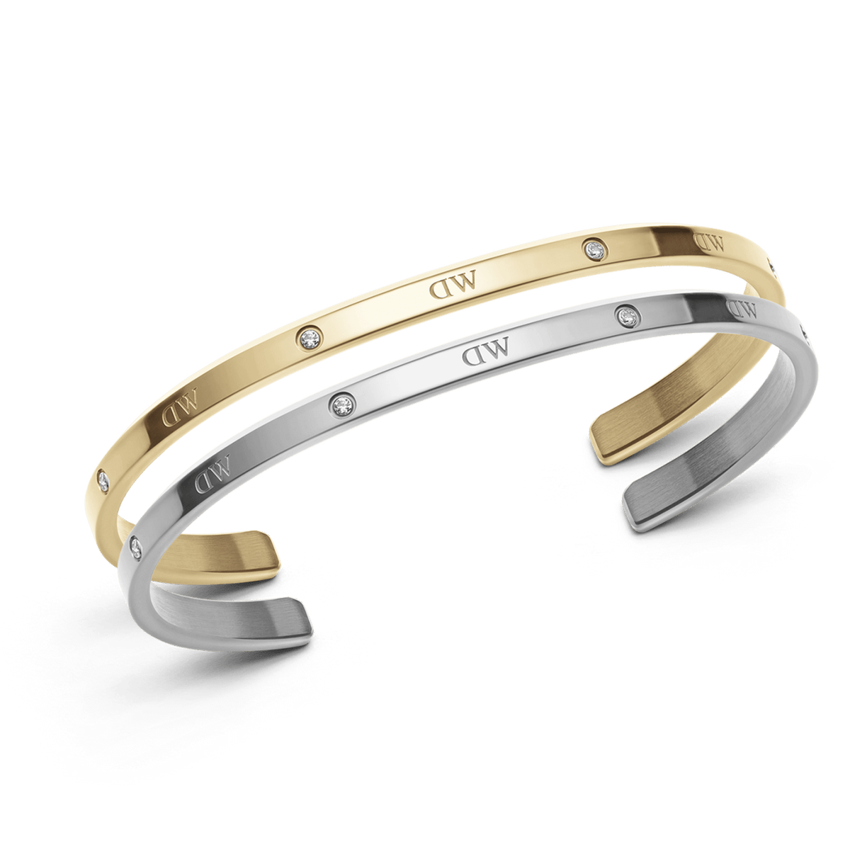 Set of two Daniel Wellington open cuff bracelets in polished silver and gold tones, each featuring subtle crystal accents and the signature DW engraving, designed for a refined and versatile look.