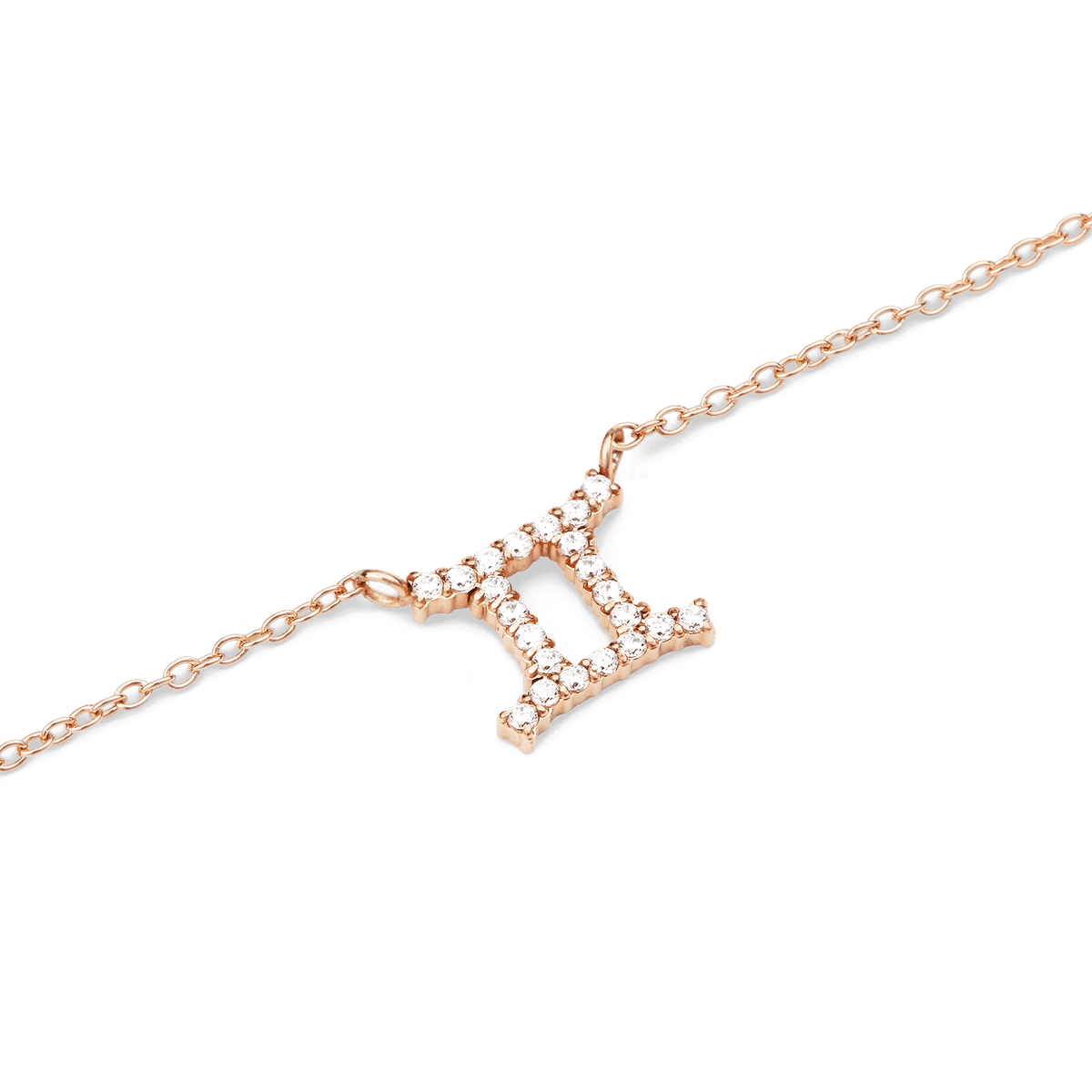 Close-up of a rose gold chain necklace featuring a Gemini zodiac pendant adorned with sparkling hand-set crystals.