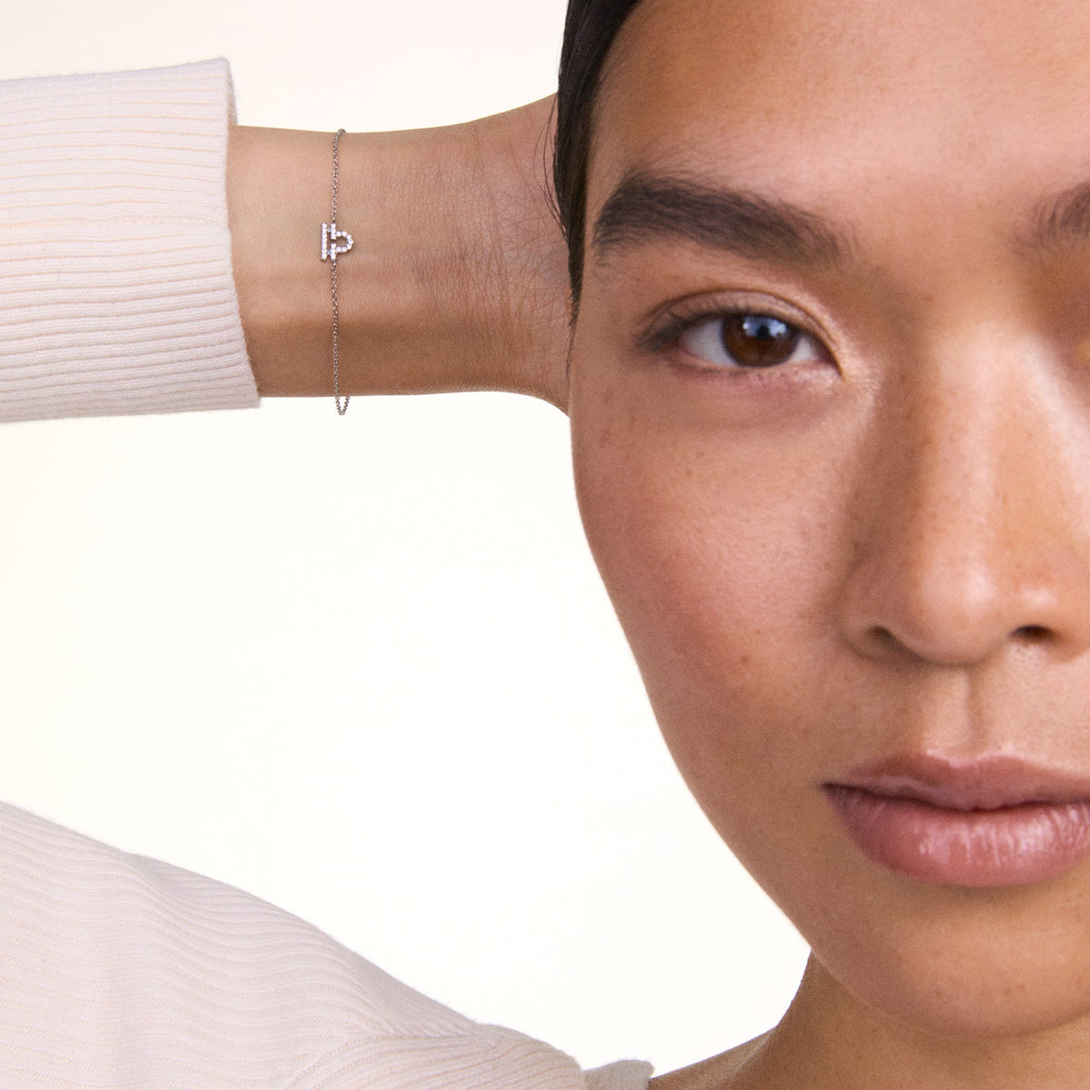 Crystal Zodiac Chain Bracelet Gold with a sparkling Libra pendant, styled on a woman's wrist for a refined and minimalist look.