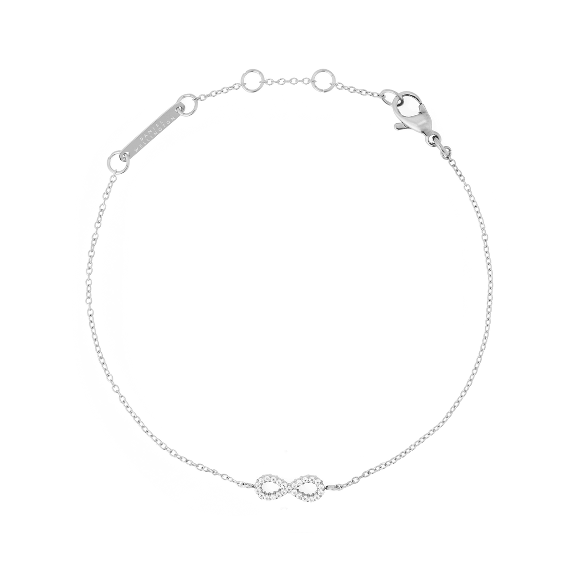 Delicate silver bracelet featuring a slender adjustable chain with a central infinity symbol adorned with white cubic zirconia crystals, crafted from polished stainless steel.
