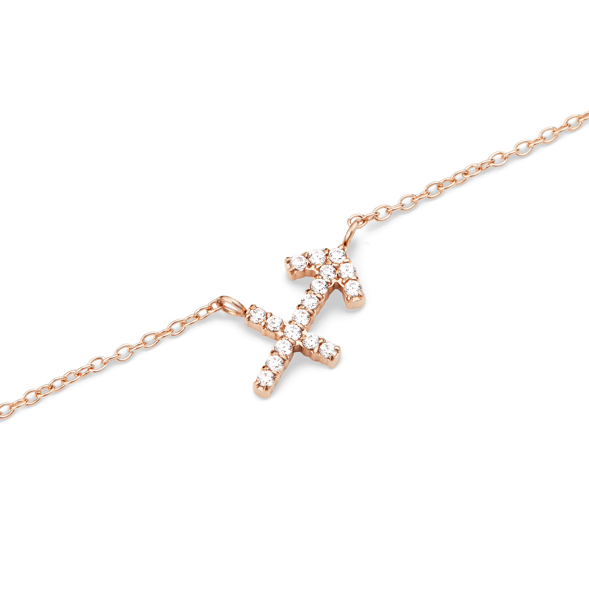Close-up of a rose gold chain necklace featuring a Sagittarius zodiac pendant adorned with hand-set sparkling crystals.