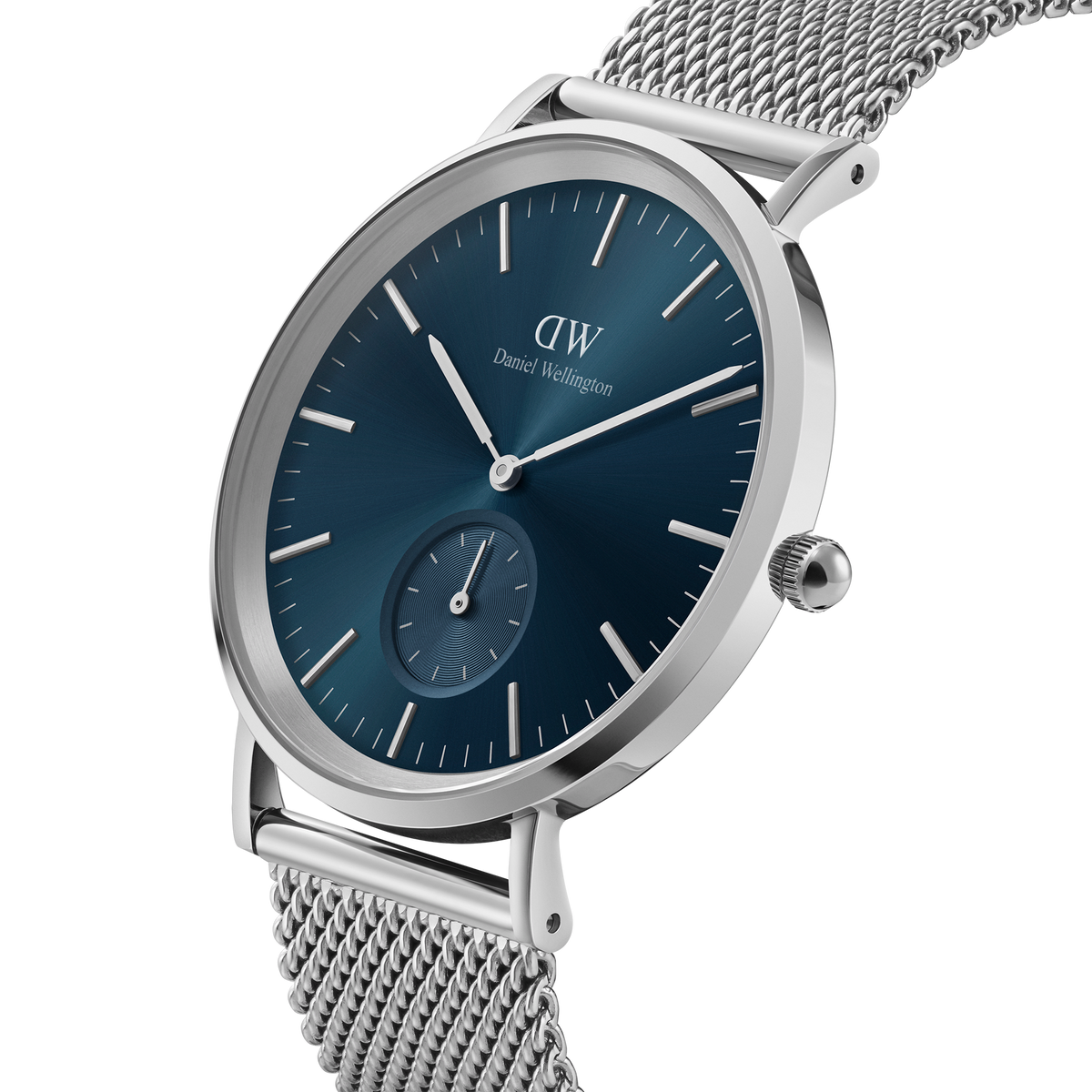 Daniel Wellington Classic Multi-Eye Sterling Arctic watch with a deep blue dial, minimalist silver hour markers, sub-dial, and a fine silver mesh strap.