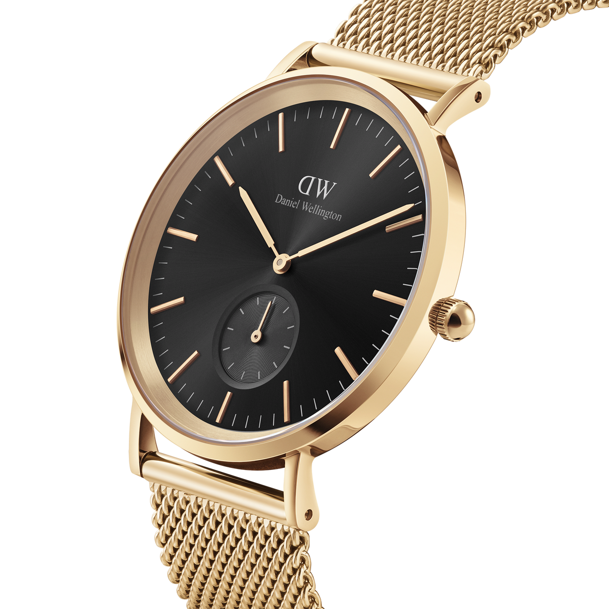 Classic Multi-Eye Evergold Onyx watch with a black multi-eye dial, gold-tone case, and a finely woven gold mesh strap shown in close-up.