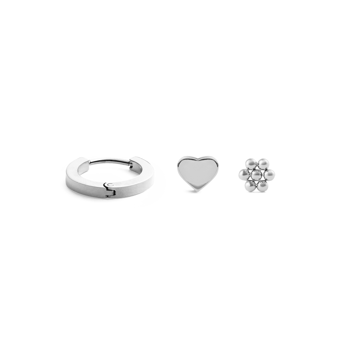 Silver earring set featuring a polished hoop, a minimalist heart stud, and a delicate flower stud, each crafted in a sleek, contemporary style and arranged side by side on a plain background.