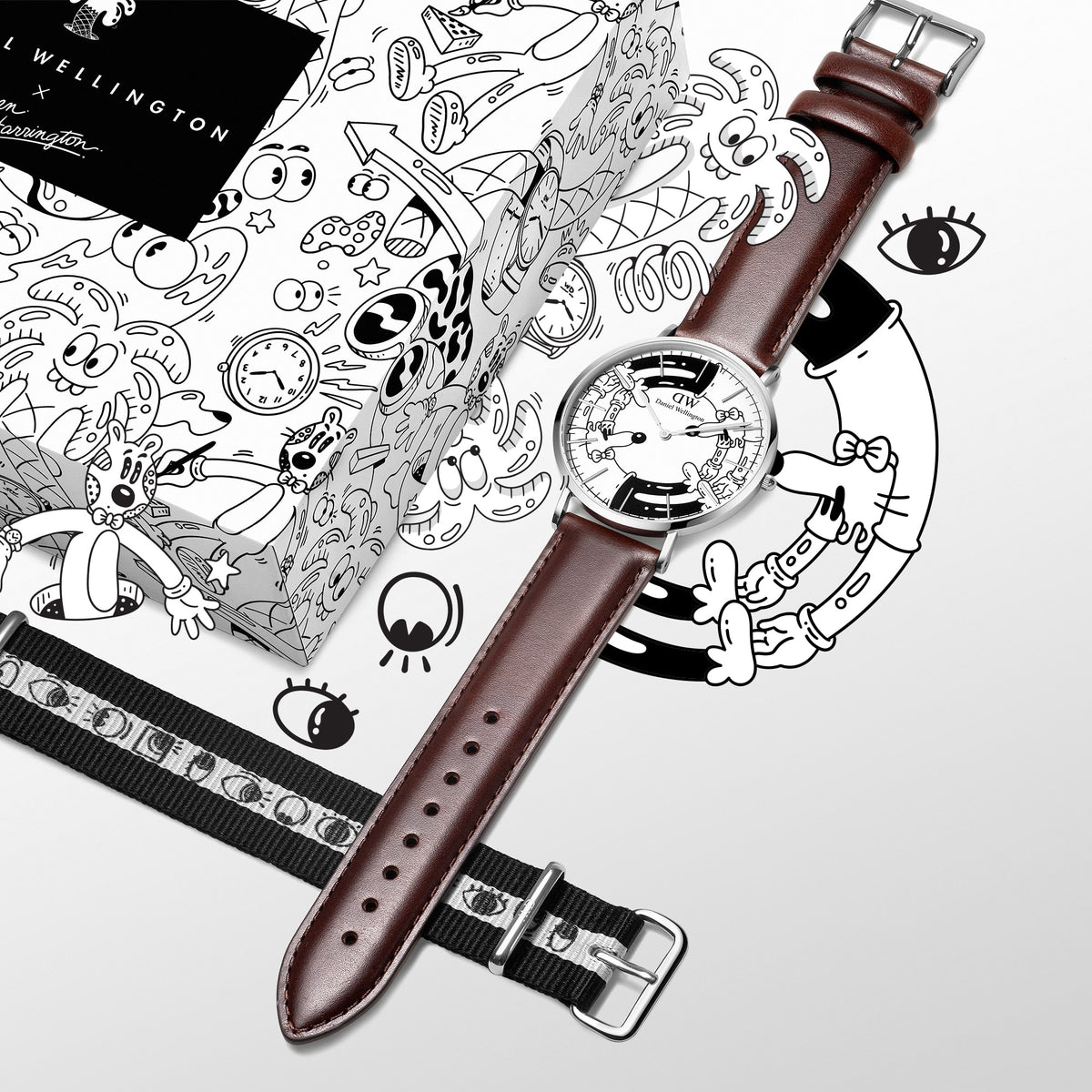 Steven Harrington x DW Bristol BW dial & Strap Silver set featuring a Daniel Wellington watch with a black and white illustrated dial, brown leather strap, and an interchangeable black and white NATO strap with eye motifs, displayed alongside a matching illustrated gift box.