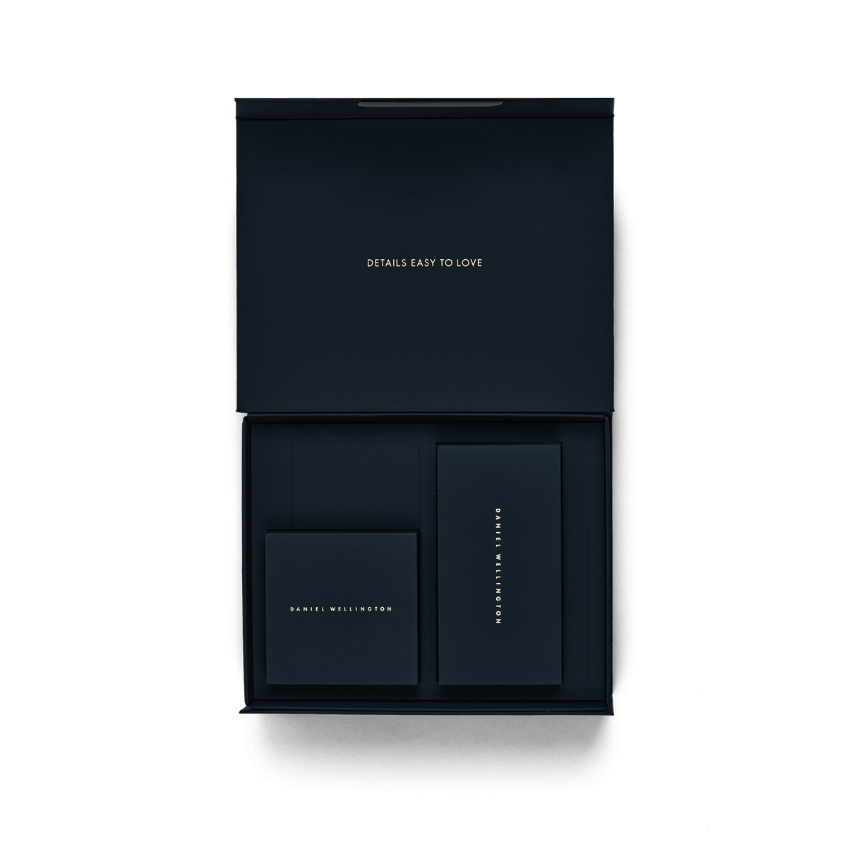 Open Premium Gift Box Blue displaying a smart interior layout with compartments and matching navy blue boxes, featuring gold Daniel Wellington branding and the phrase “Details Easy to Love” on the lid.