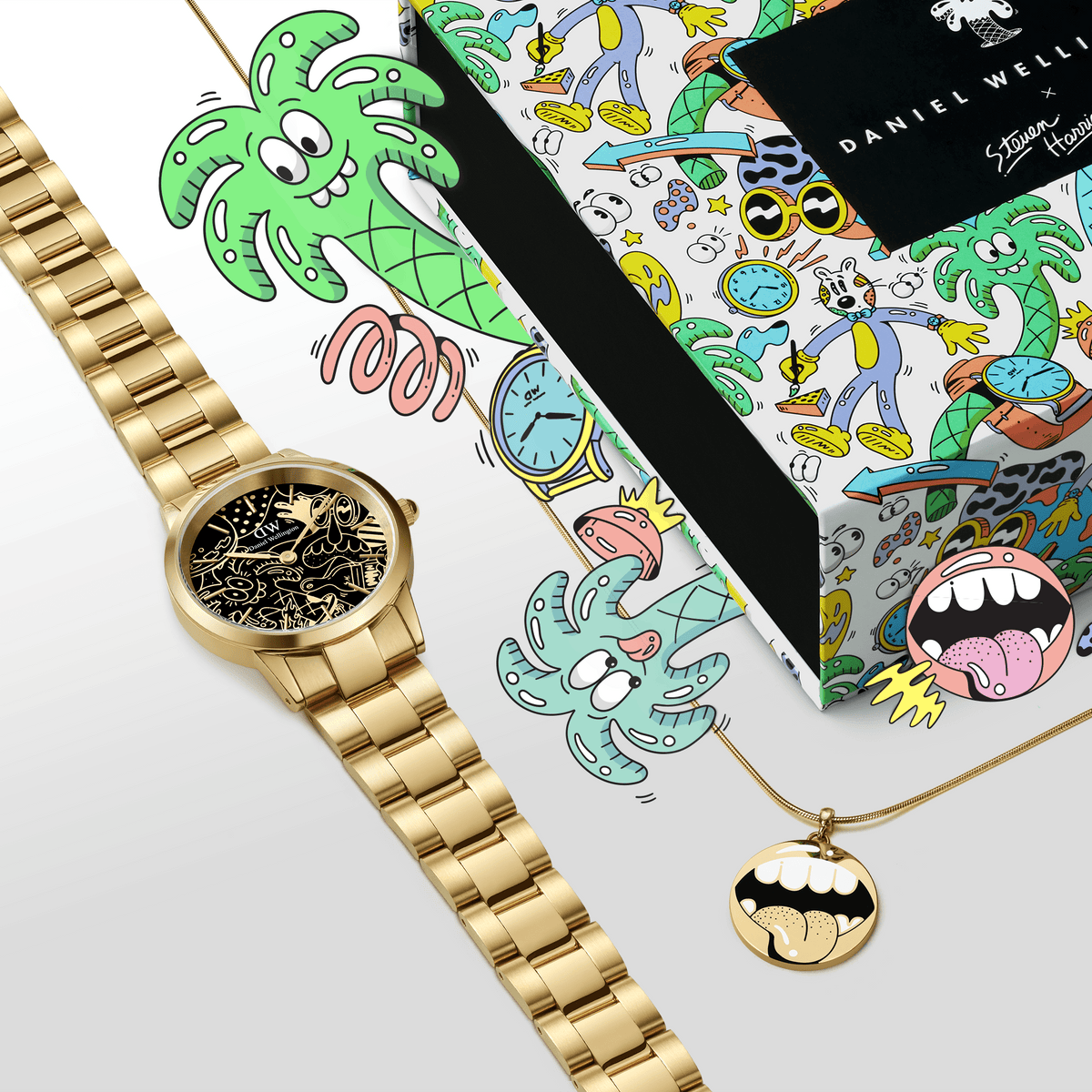 Steven Harrington x DW SET featuring a gold Daniel Wellington watch with a black illustrated dial and a matching gold pendant necklace, presented alongside a vibrant, artist-designed gift box decorated with playful cartoon graphics.