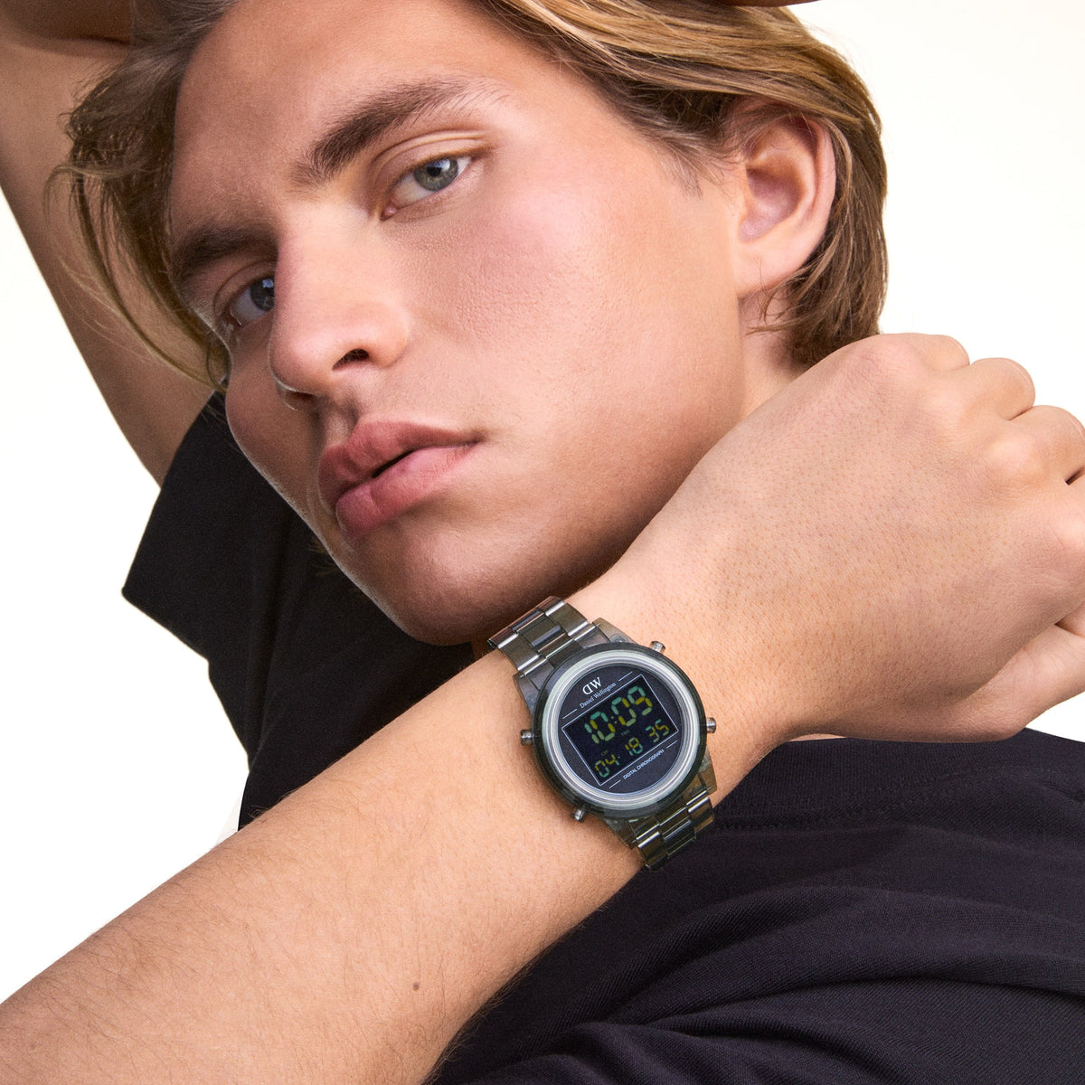 Model wearing the Retro Digital Dark Green watch with a transparent dark green link strap and black digital dial, styled with a casual black t-shirt.