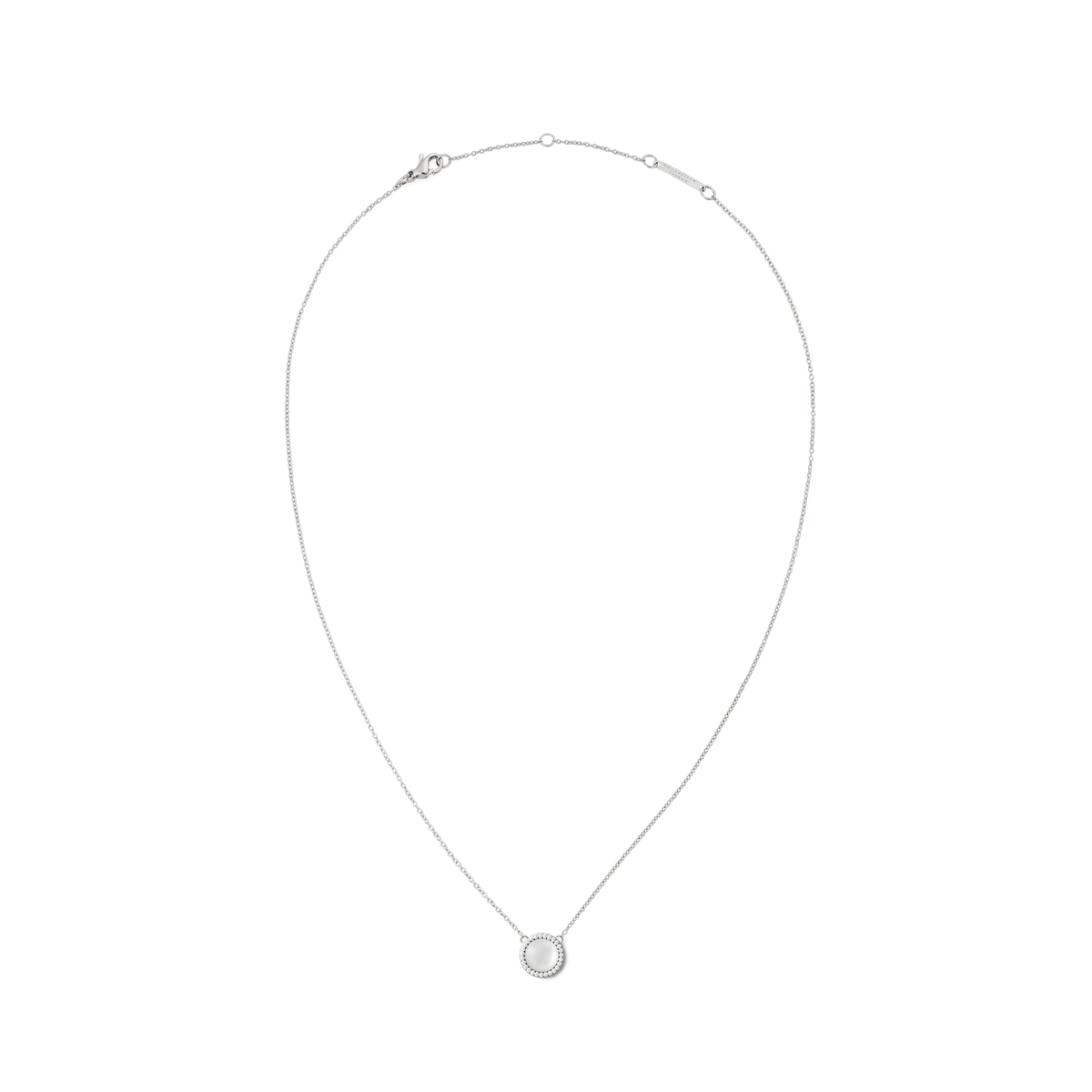 Delicate silver necklace with a round mother of pearl pendant, cubic zirconia accents, and adjustable chain.