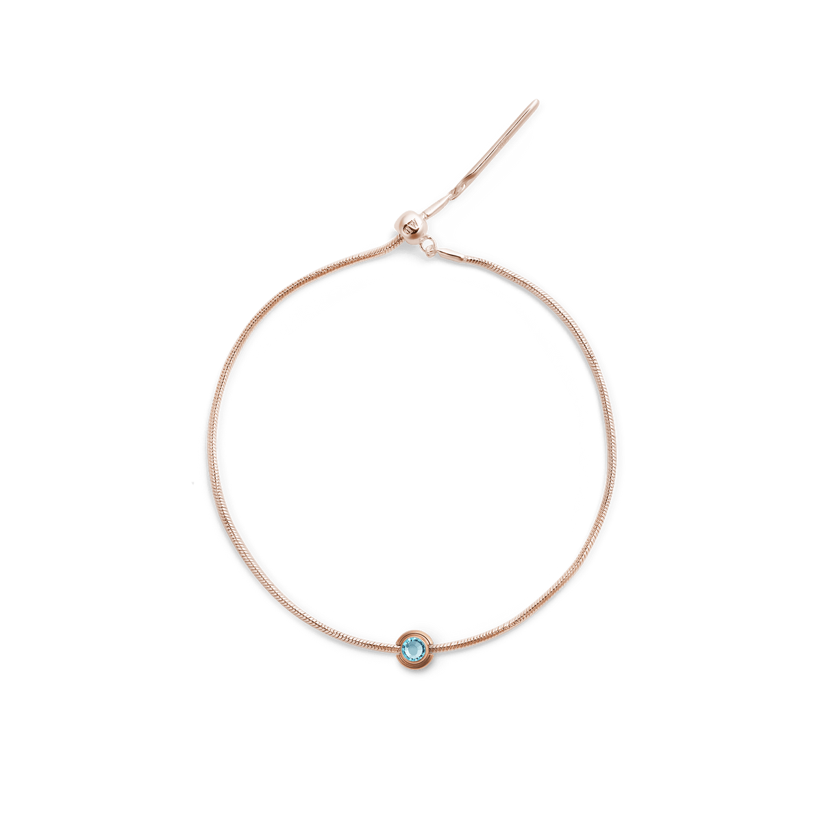 Rose gold bracelet featuring the December Charm with a central blue crystal, set on a slim adjustable chain for a refined and elegant finish.