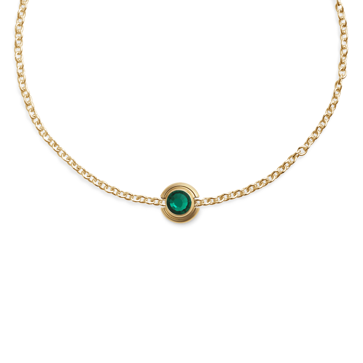 Gold chain necklace featuring a small circular charm with a vibrant green crystal set in polished gold plated stainless steel.