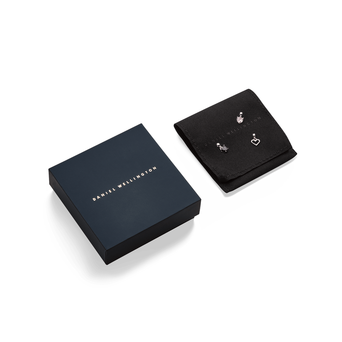 Heart White Crystal Charm S925 Sterling Silver presented on a black jewellery pouch alongside two other silver charms, with a sleek Daniel Wellington gift box included.