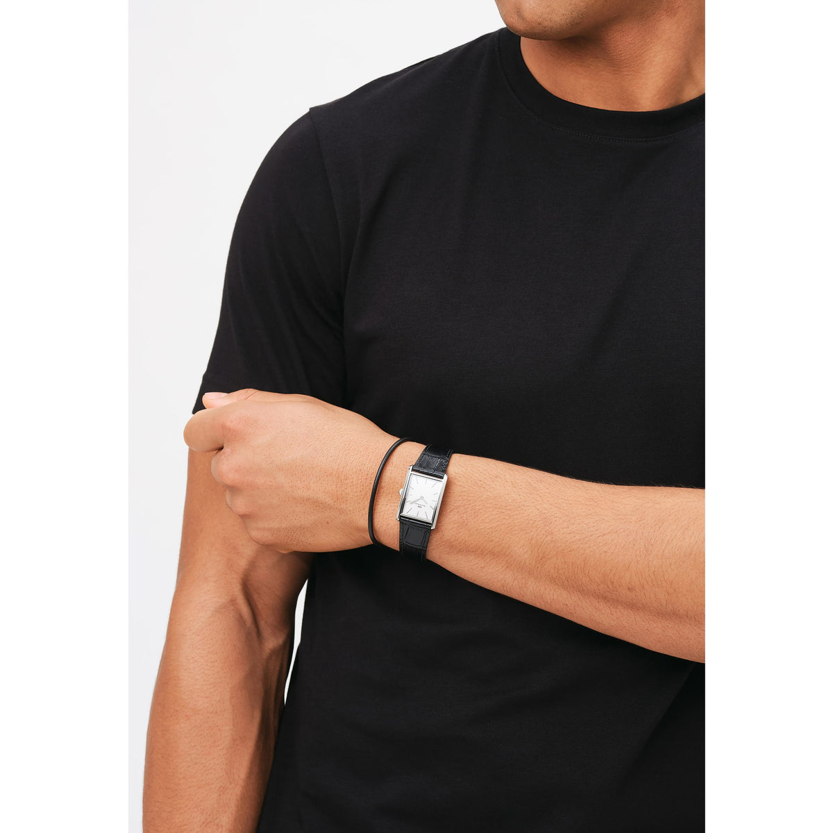 Man wearing Bound Black Crocodile Silver watch with rectangular silver case and black crocodile leather strap, styled casually.