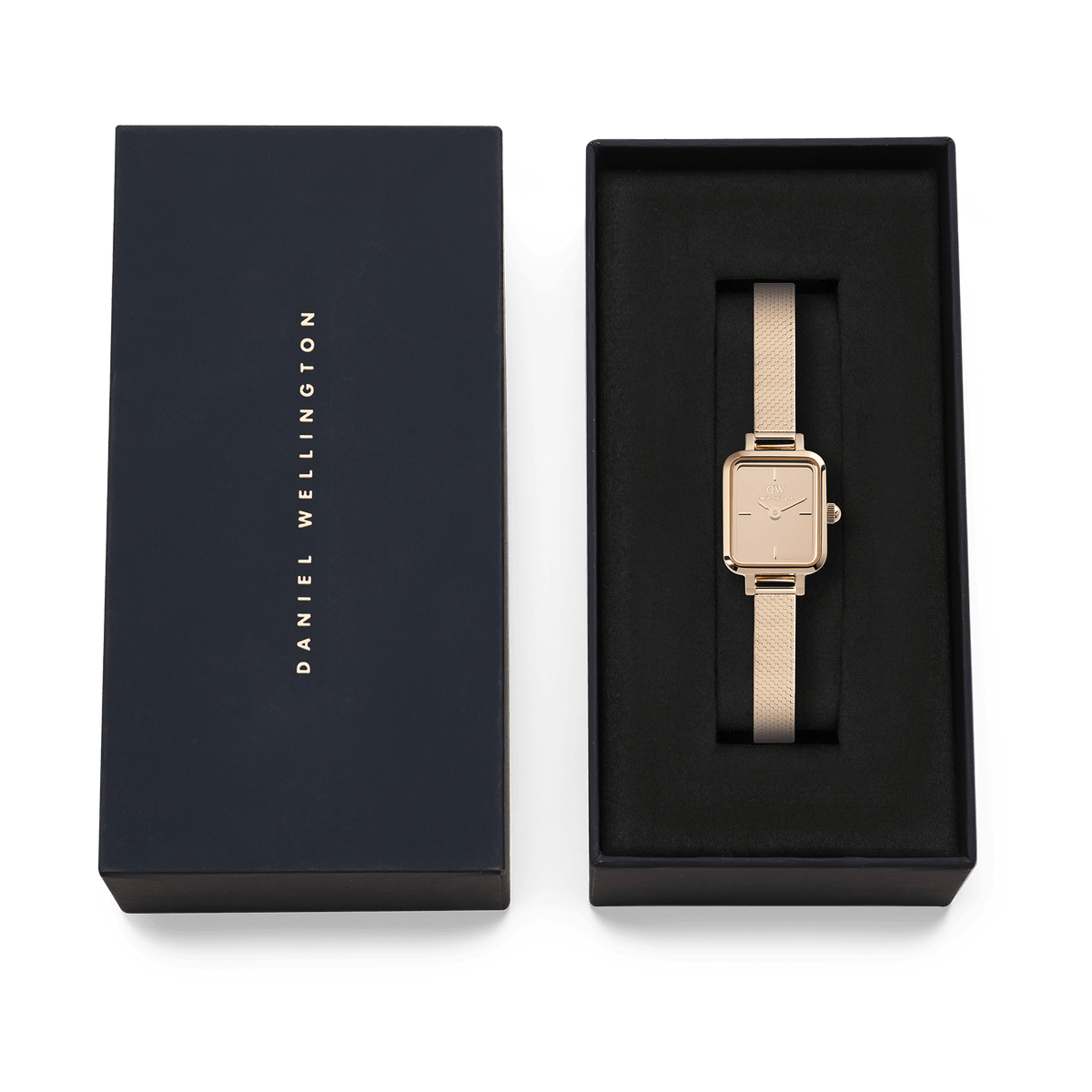 Quadro Mini Reflection Rose Gold watch with a rectangular mirror dial and rose gold mesh strap, elegantly presented in a black Daniel Wellington gift box.