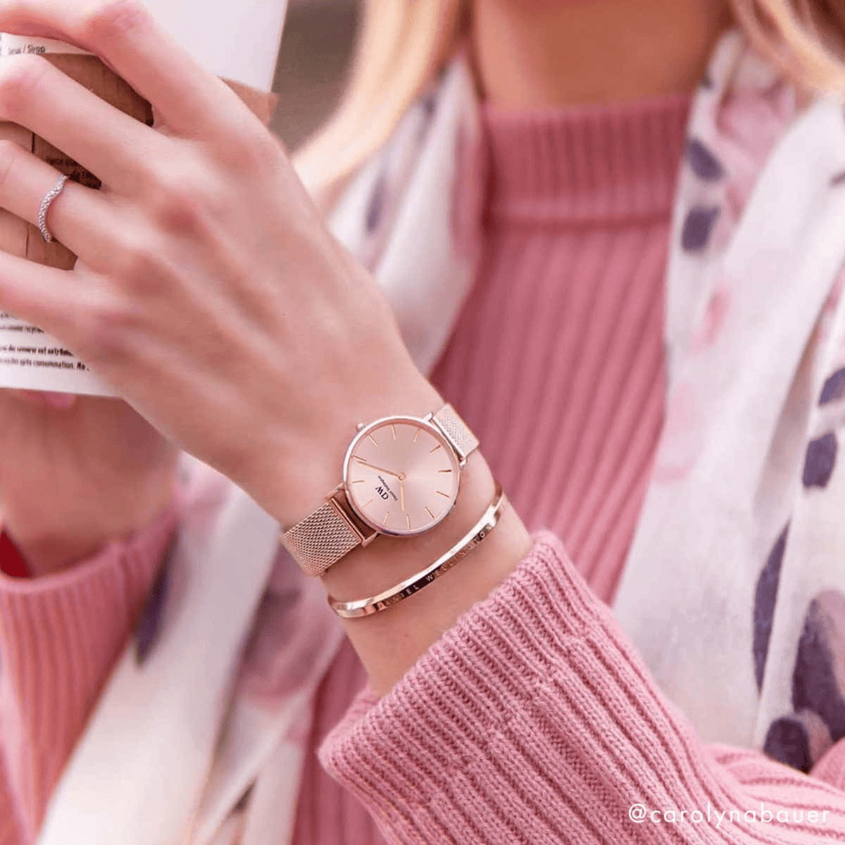 Woman wearing the Petite Melrose Light Pink watch with a rose gold mesh strap, styled alongside a matching bangle and a pink knit jumper.