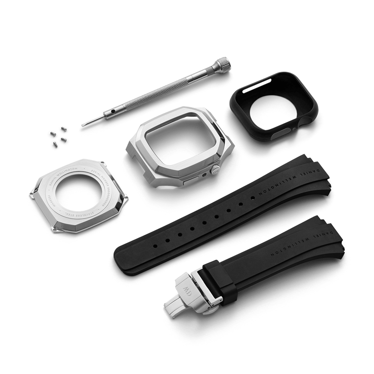 Daniel Wellington Switch Silver Apple Watch case kit featuring a brushed stainless steel geometric case, black rubber strap with deployment clasp, back plate, screws, screwdriver, and protective insert.