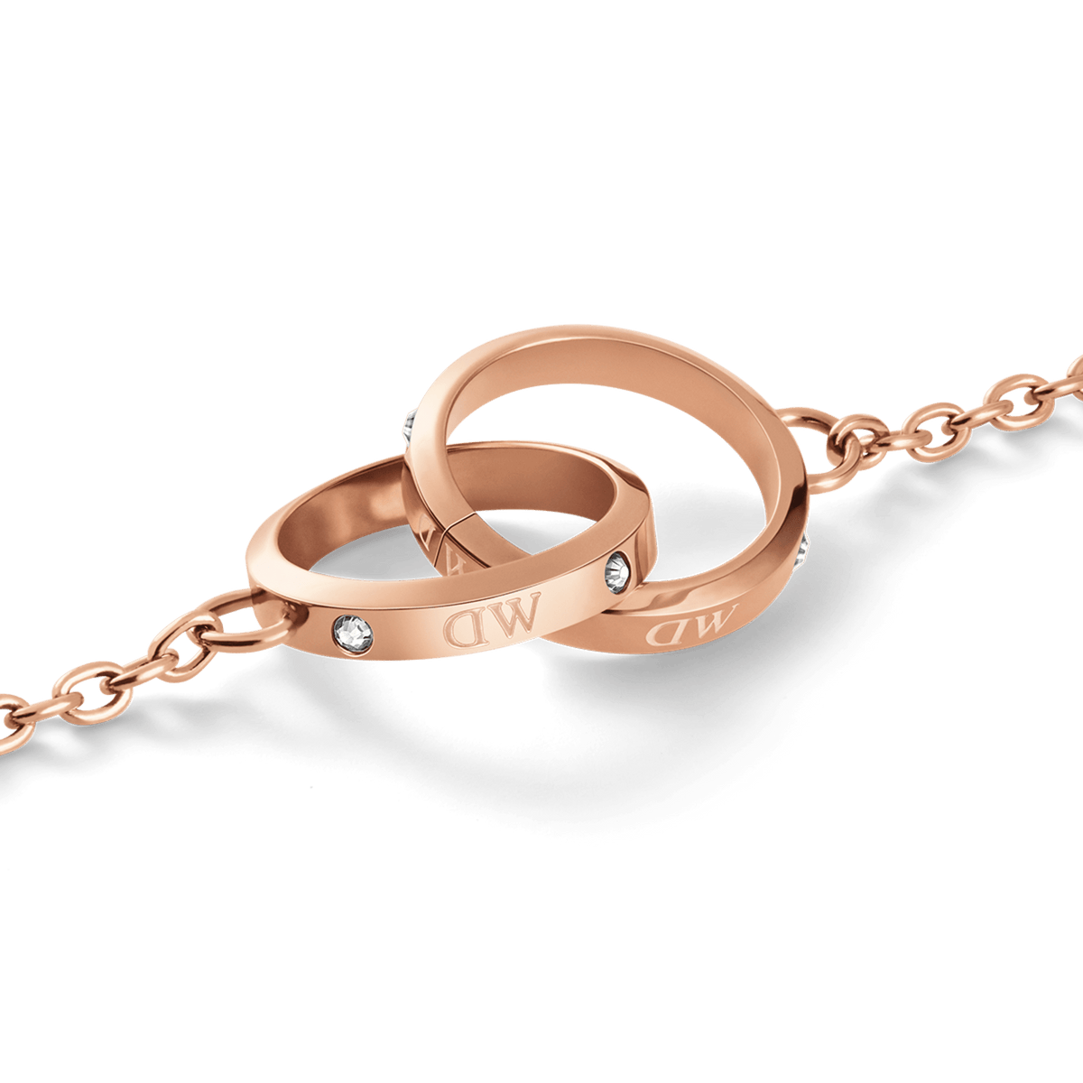 Close-up of the Classic Unity Lumine rose gold bracelet showing two intertwined rings with crystal accents and subtle engraved logotype on a delicate chain.