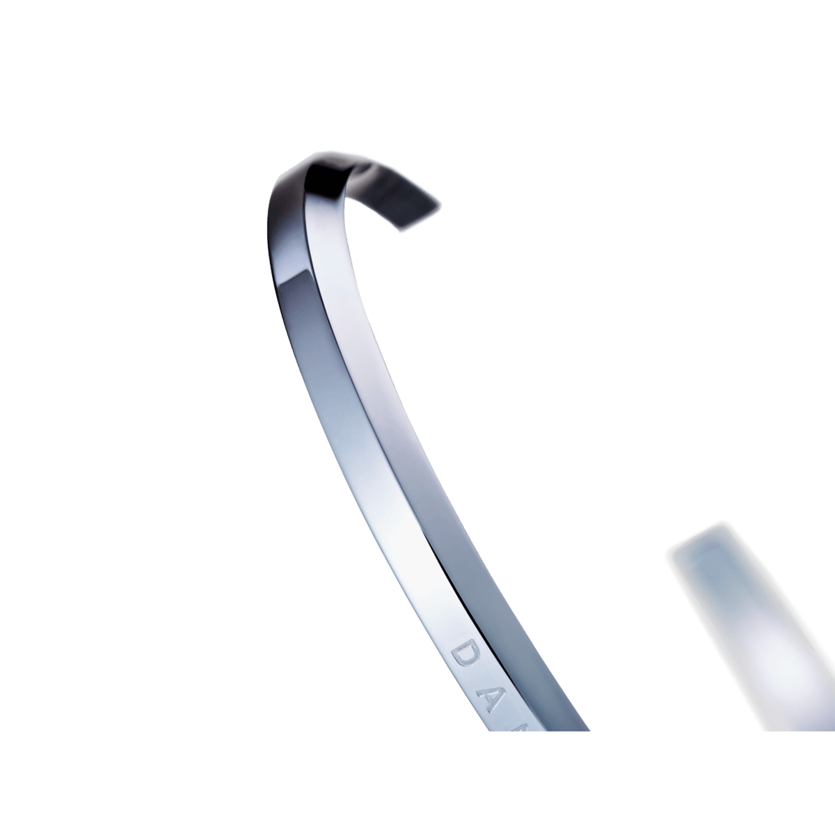 Close-up of the Classic Bracelet Silver highlighting its polished stainless steel finish, slim open cuff design, and subtle engraved detailing.