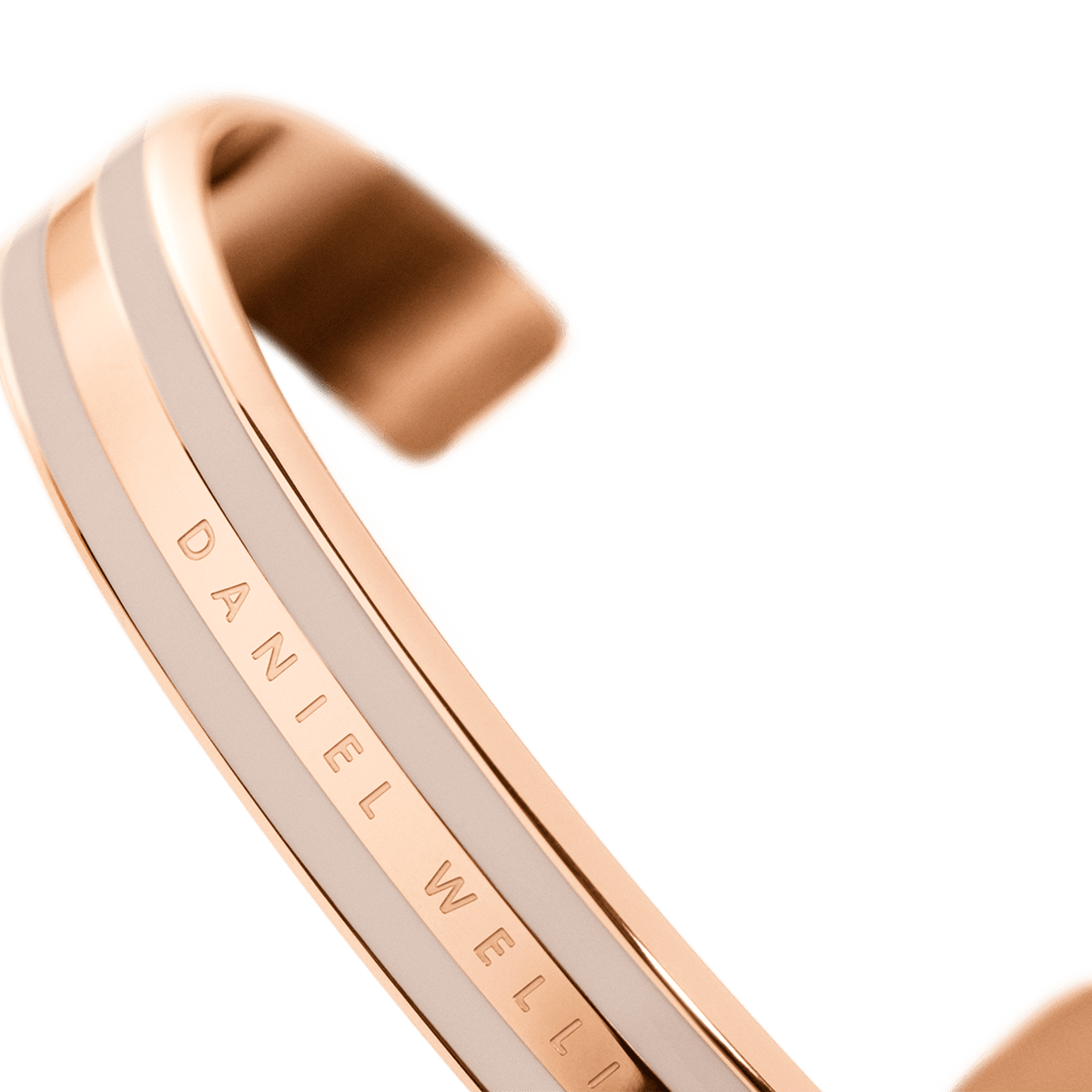 Detail view of the Daniel Wellington Emalie Bracelet Desert Sand Rose Gold, highlighting the rose gold finish, Desert Sand enamel, and engraved logo on the open cuff.