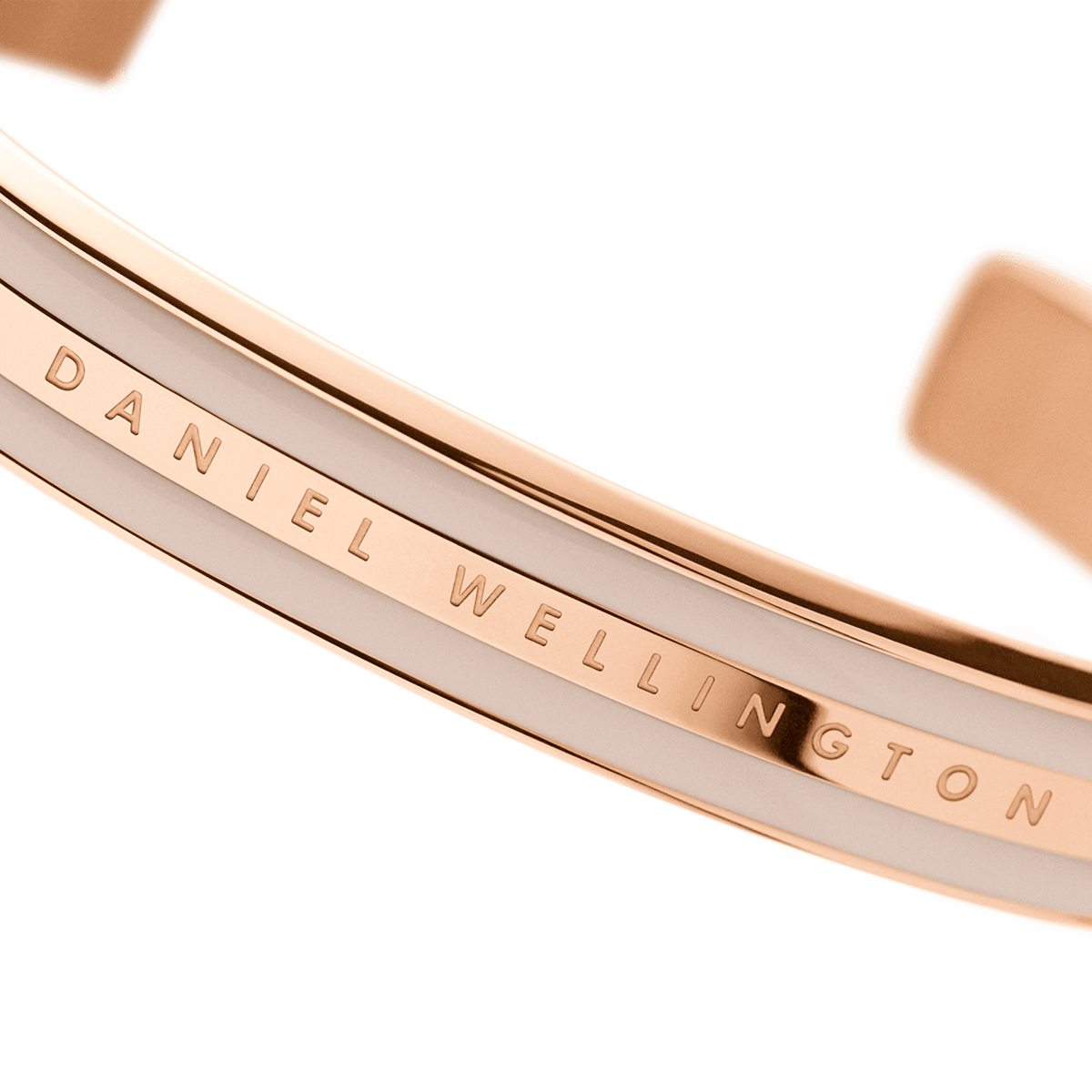Close-up of the Daniel Wellington Emalie Bracelet Desert Sand Rose Gold, showing the engraved logo, rose gold finish, and Desert Sand enamel accent.