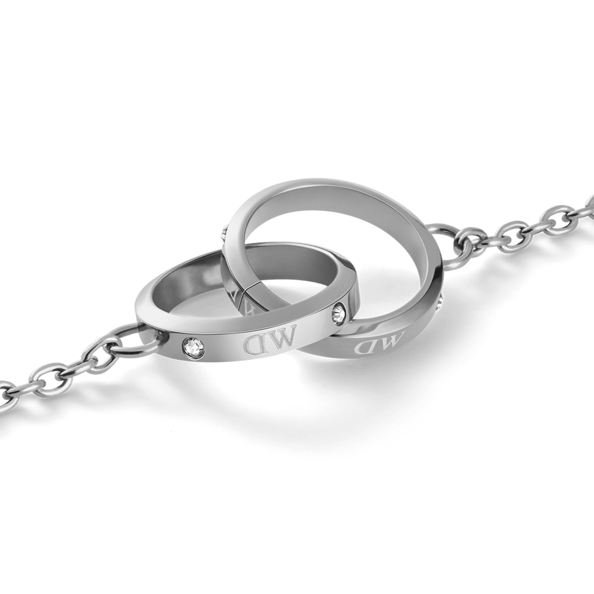 Close-up of the Classic Lumine Unity Silver necklace showing two interlocking polished silver rings engraved with DW and set with sparkling Preciosa crystals on a fine chain.